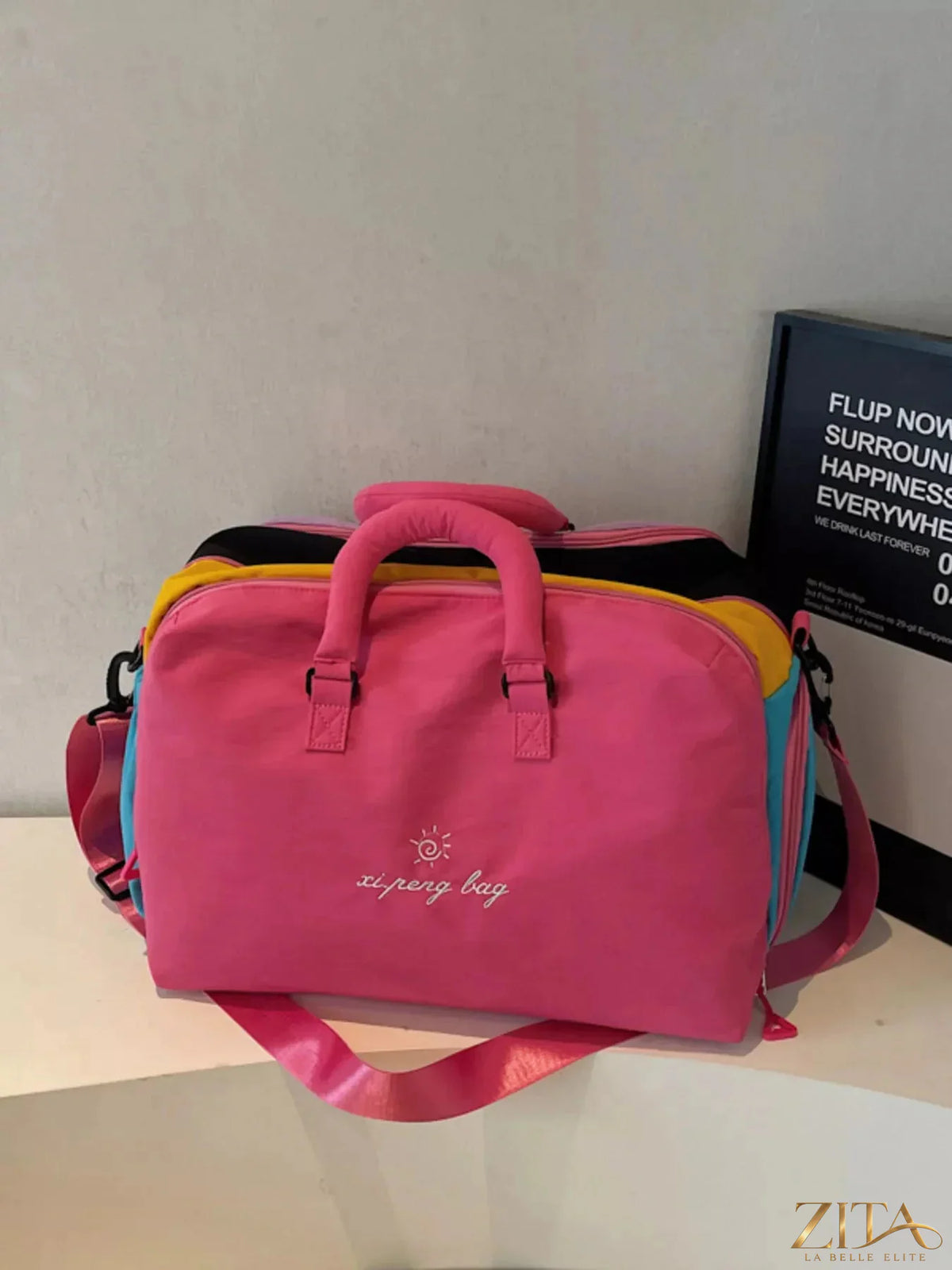 Colorful lightweight travel duffel bag by Zita La Belle Elite, showing vibrant fabric and sturdy handles for easy carrying.