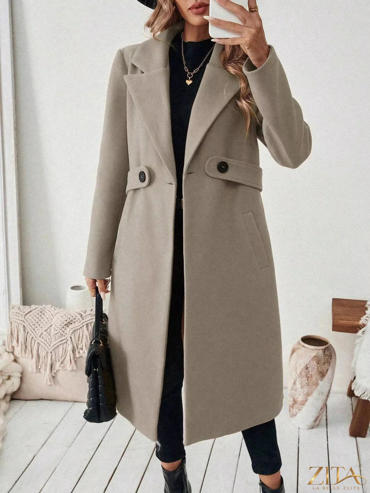 Zita La Belle Elite one-button lapel collar overcoat in classic black, shown hanging on a wooden hanger with a tailored fit.