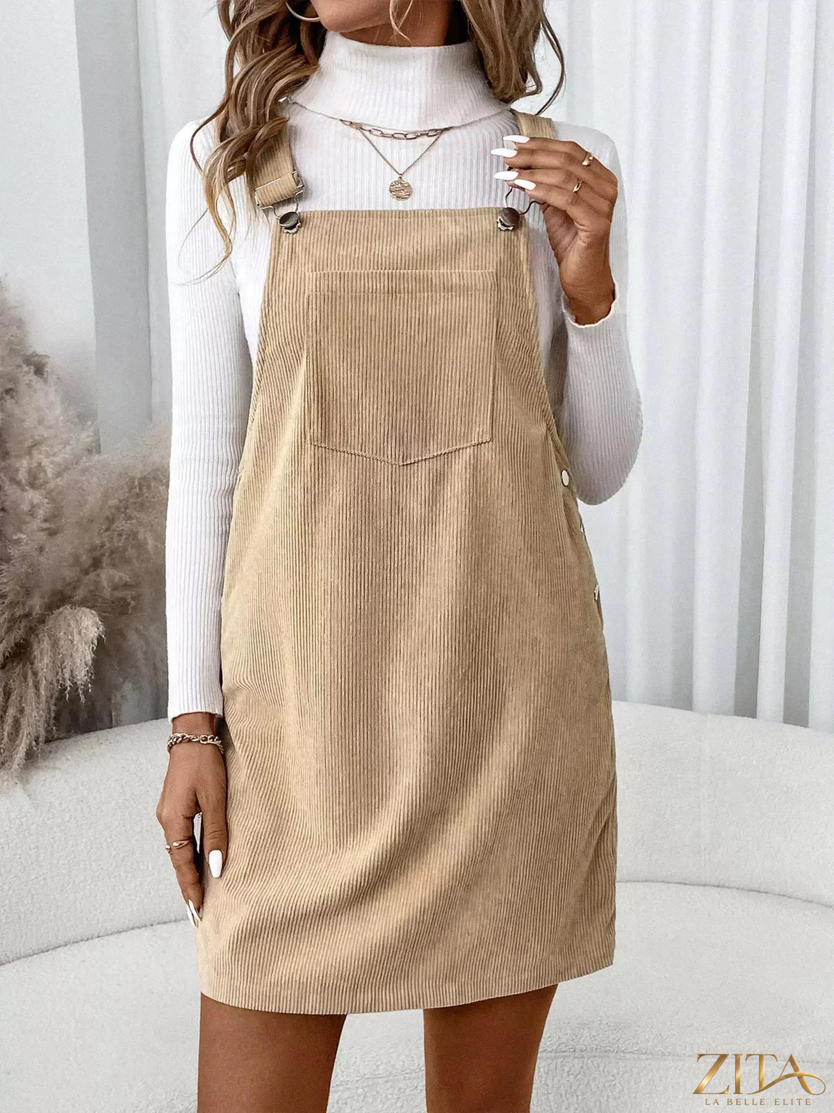 Zita La Belle Elite casual corduroy overall dress displayed on a hanger, featuring a fitted bodice and wide-leg style.