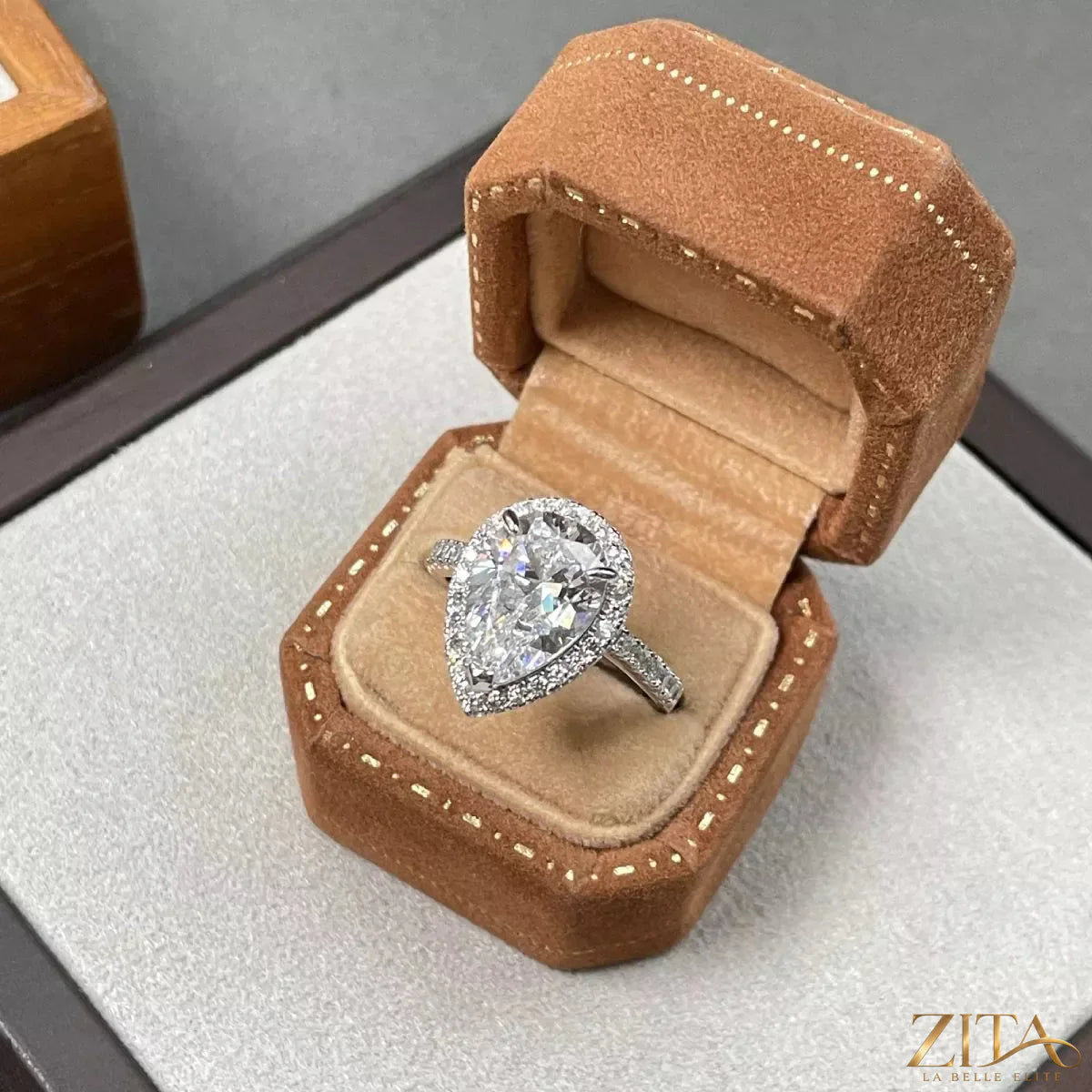 Sterling silver moissanite teardrop ring with 4 carats, featuring a sparkling gemstone and elegant design.