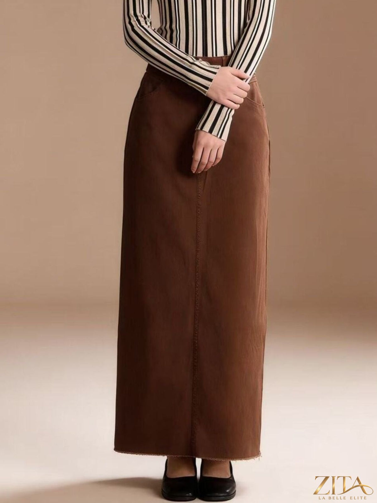 Raw hem maxi denim skirt by Zita La Belle Elite, featuring a flowy design with distressed raw hem and classic denim texture.