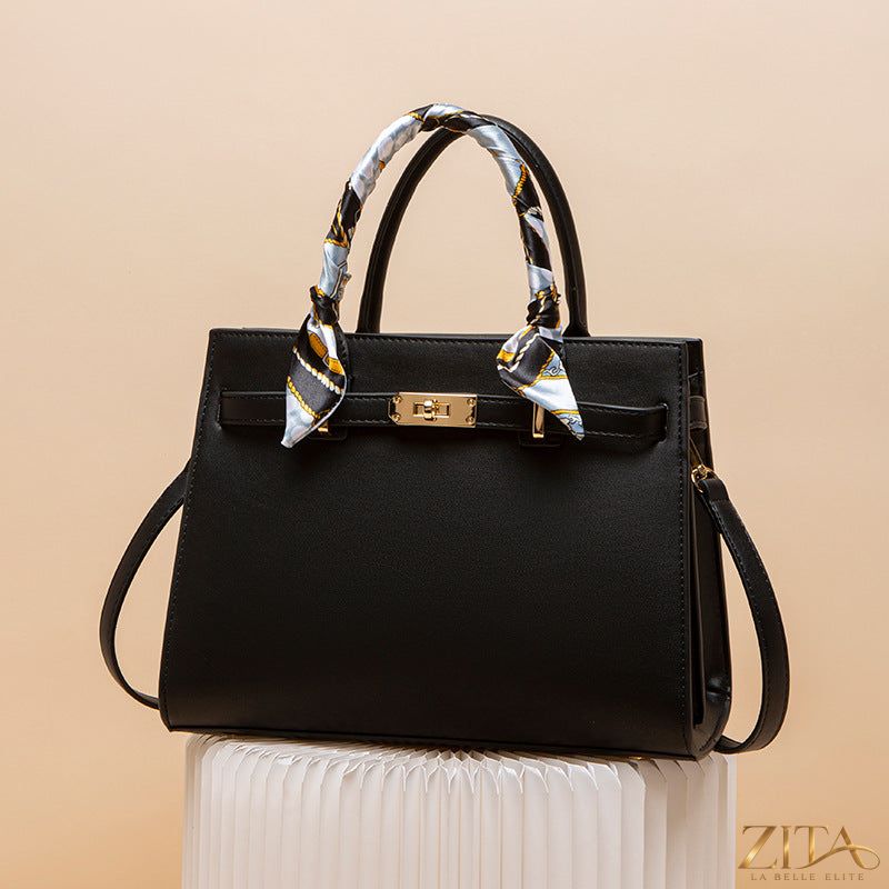 Zita La Belle Elite top handle leather handbag with structured design and gold-tone hardware, featuring a sleek, stylish appearance.