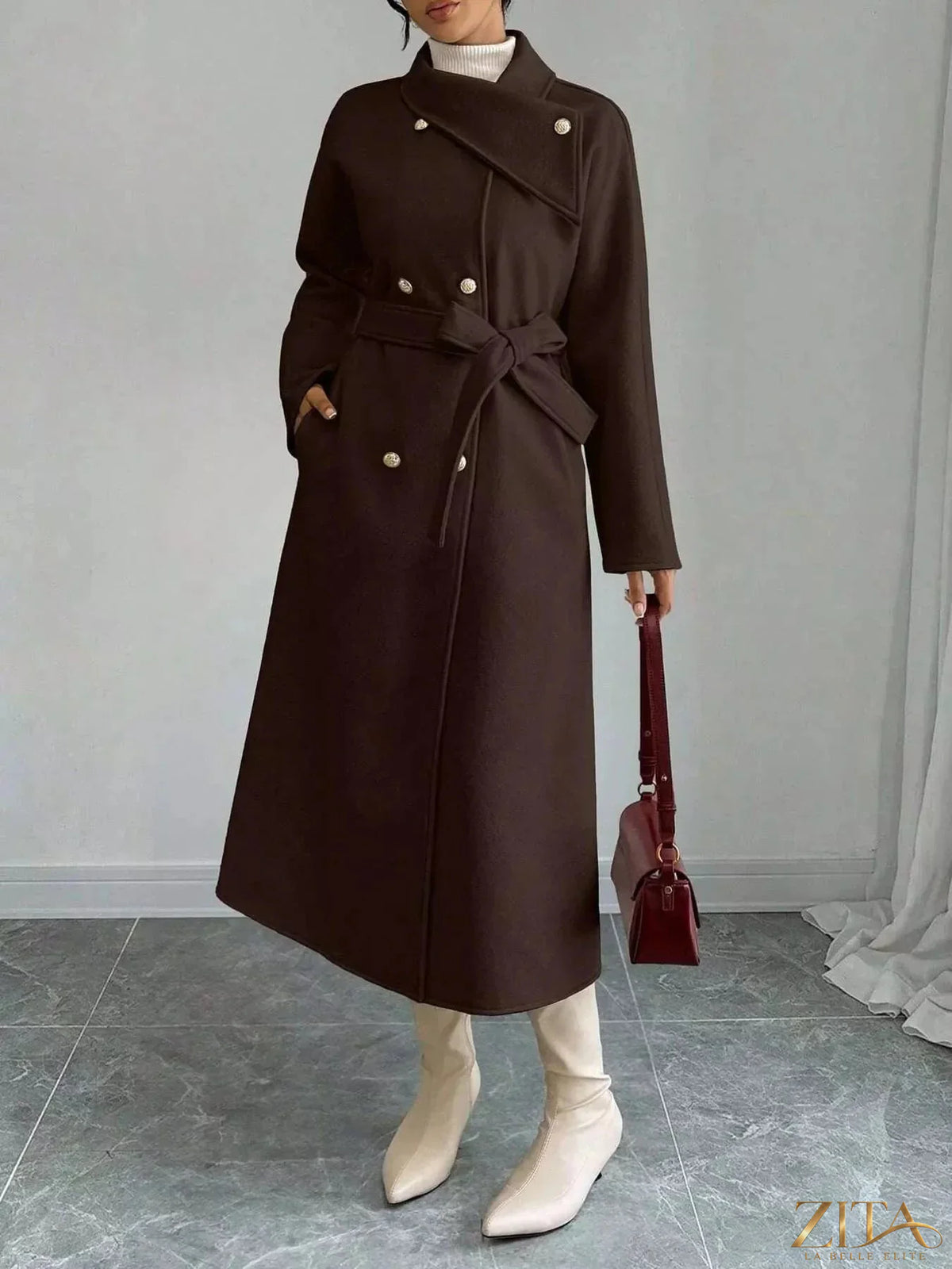 Zita La Belle Elite double-breasted longline coat displayed on a hanger, showcasing its sleek design and tailored fit.
