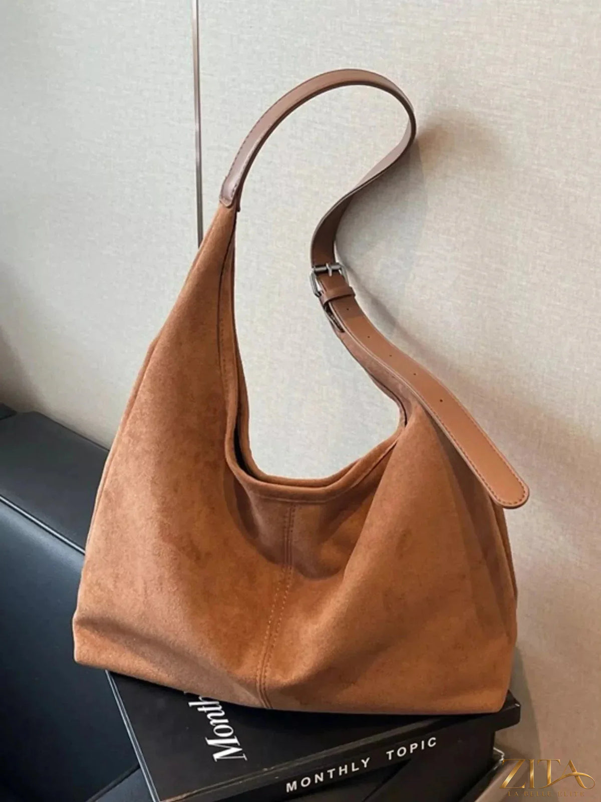Lightweight Zita La Belle Elite adjustable strap handbag with sleek design and neutral color, displayed on a plain background.