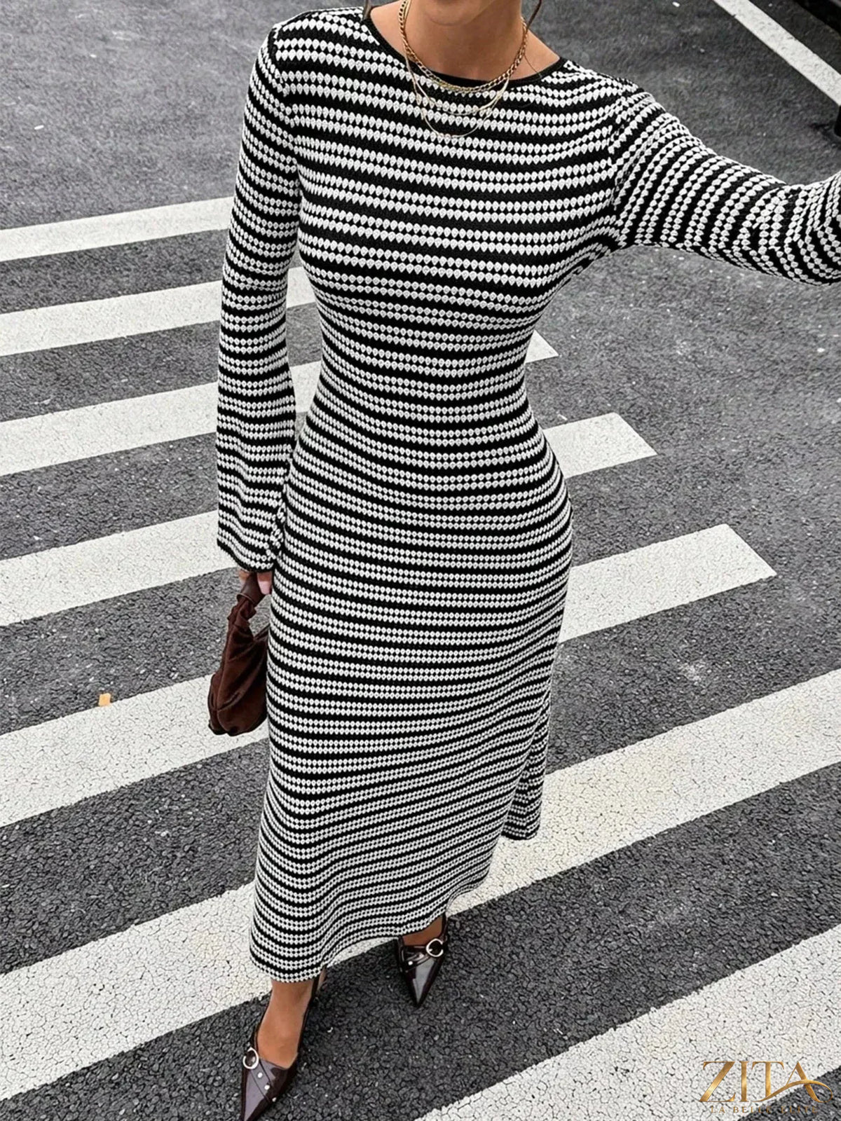 Zita La Belle Elite striped flared sleeves sweater dress with bold pattern, fitted bodice, and flowing flare at the sleeves.