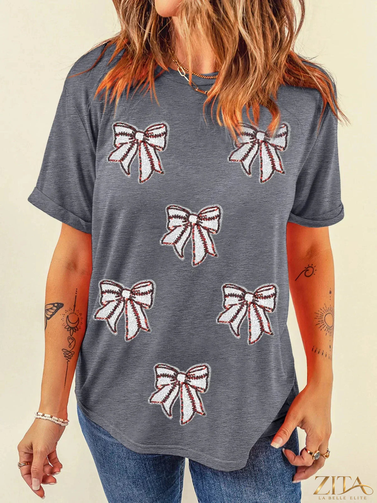 Sequin bow short sleeve T-shirt by Trendsi featuring a stylish design with a sequin bow detail on the front.