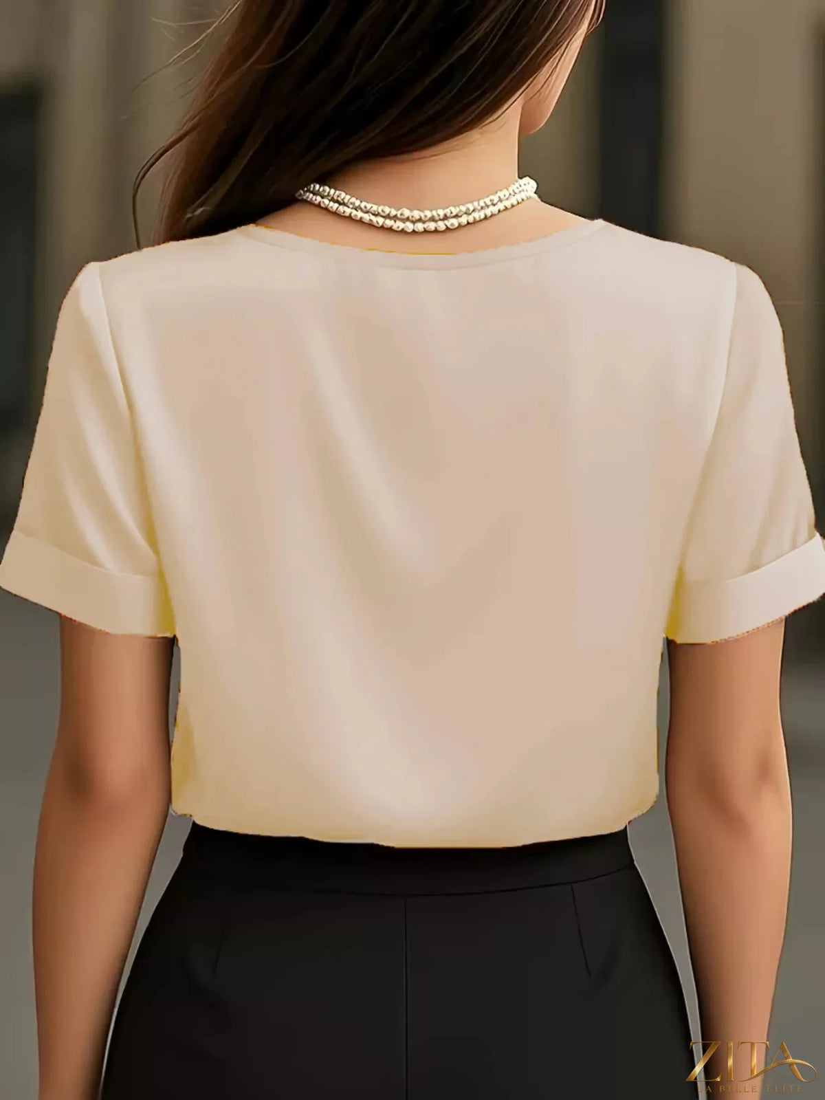 Zita La Belle Elite satin V-neck short sleeve blouse in elegant fabric, displayed on a hanger.