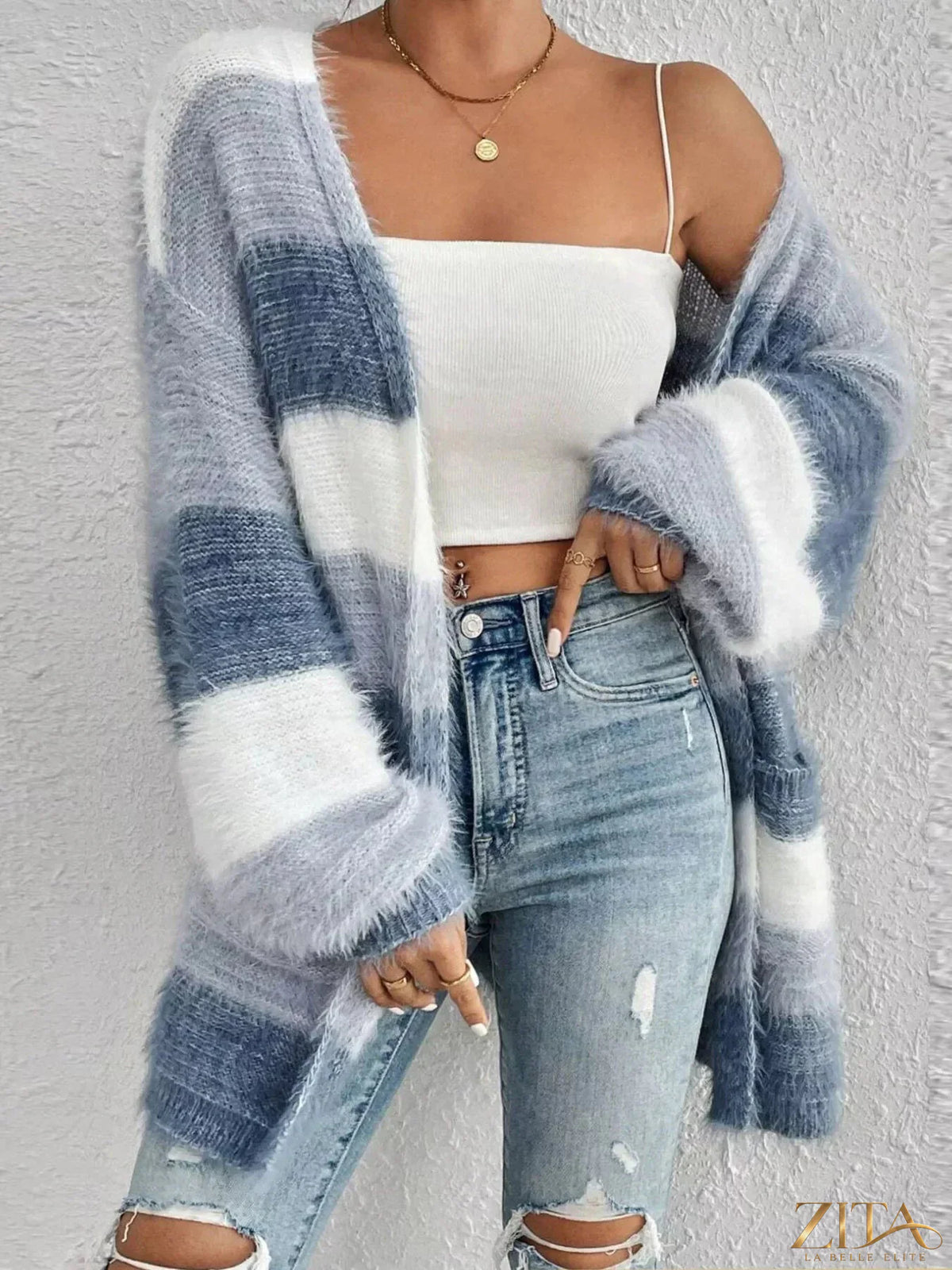 Zita La Belle Elite striped open front oversized cardigan hanging on a wooden hanger against a neutral background.