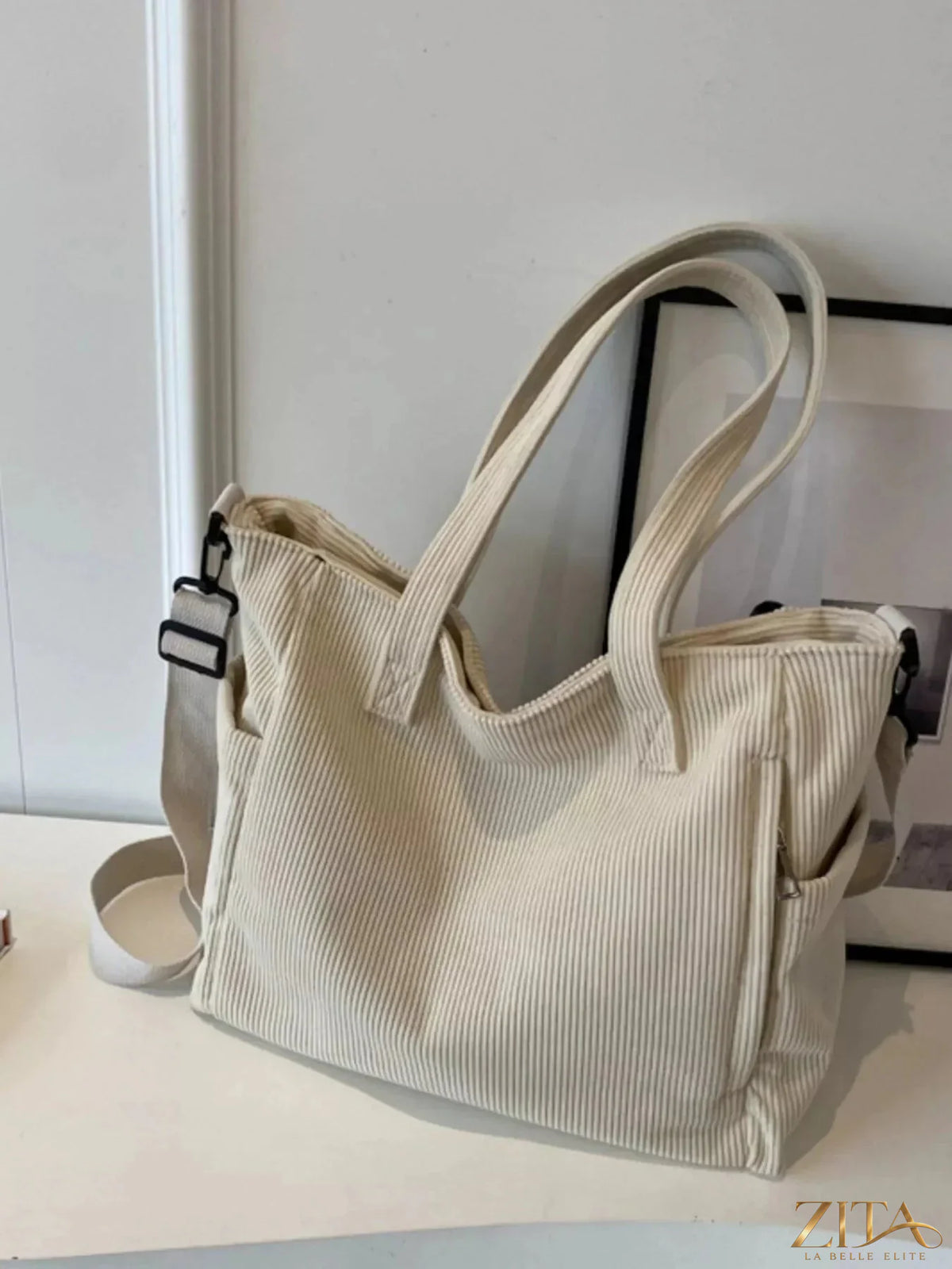 Zita La Belle Elite corduroy solid color handbag with rounded top handle and gold-tone hardware on a neutral background.
