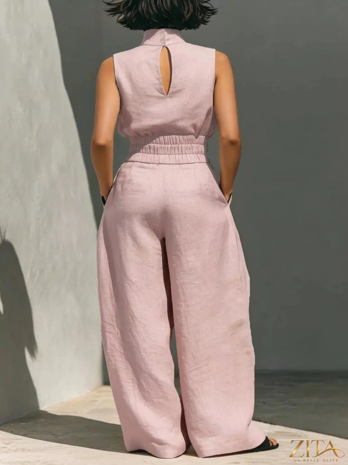 Sleeveless turtleneck top and wide-leg pants set by Trendsi, featuring a stylish, coordinated outfit with a modern silhouette.