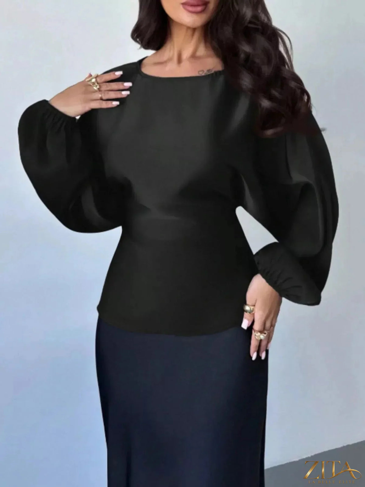 Zita La Belle Elite back tie long sleeve blouse with v-neck and fitted design, in a soft fabric, displayed on a hanger.
