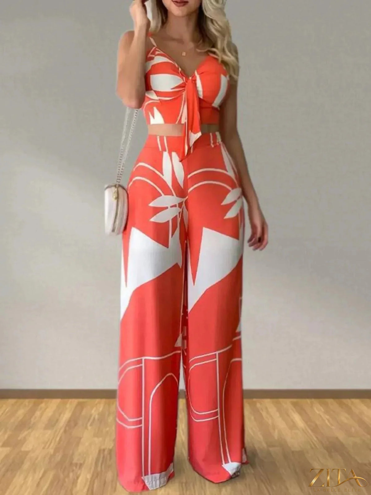 Zita La Belle Elite tropical print spaghetti strap crop top and wide leg pants set on a model, vibrant summer fashion look.