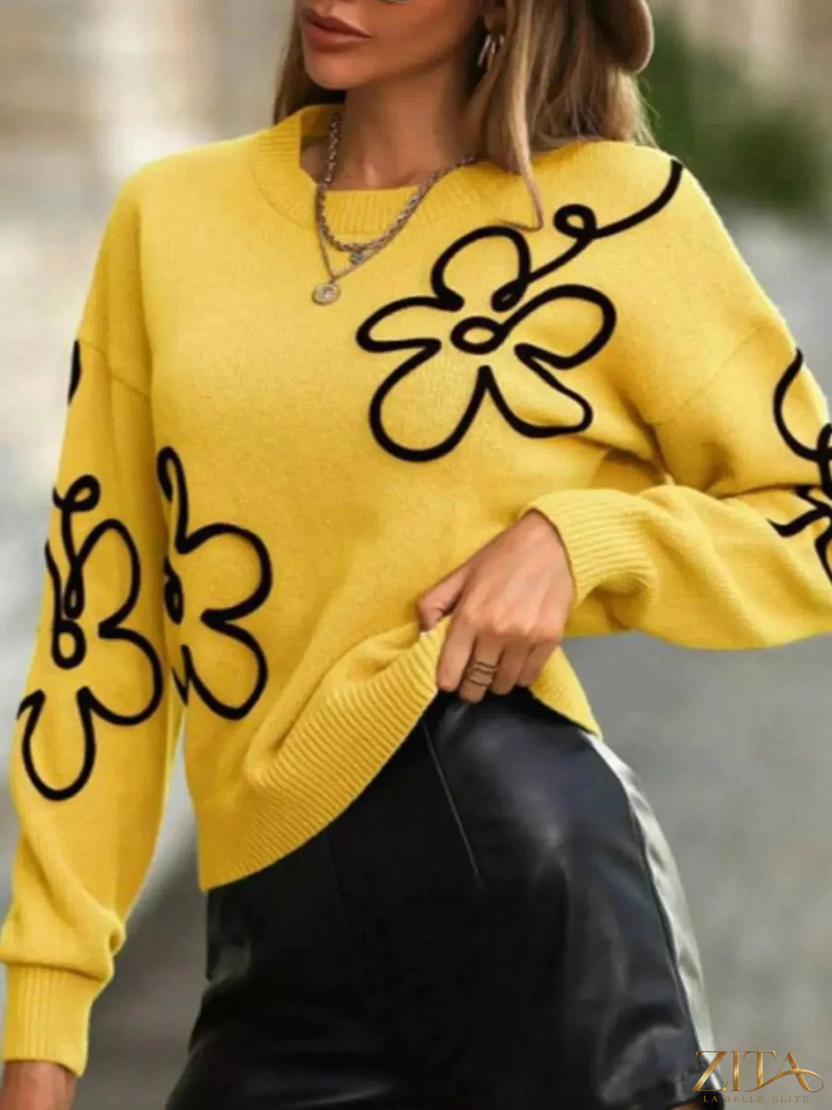 Flower dropped shoulder sweater by Trendsi featuring a soft knit fabric and floral pattern with a relaxed fit.