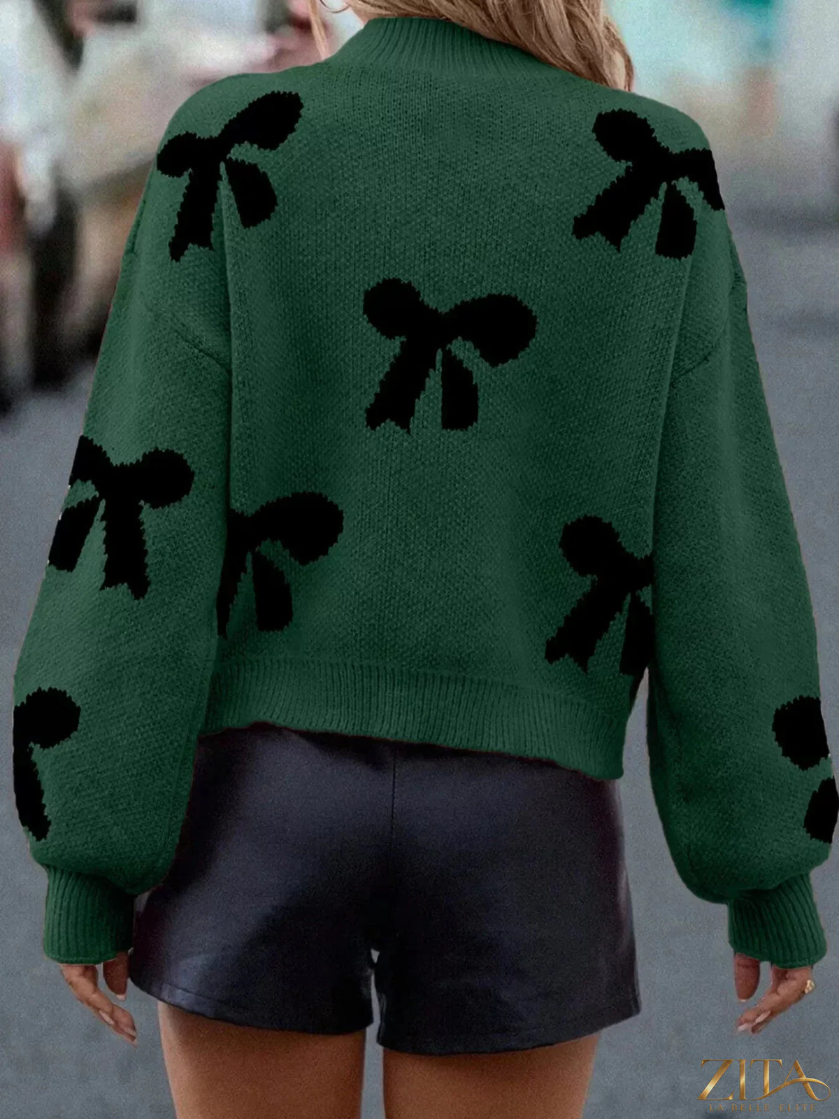 Zita La Belle Elite pearl bow-embellished long sleeve sweater featuring a cozy knit fabric and decorative pearl accents on the front.