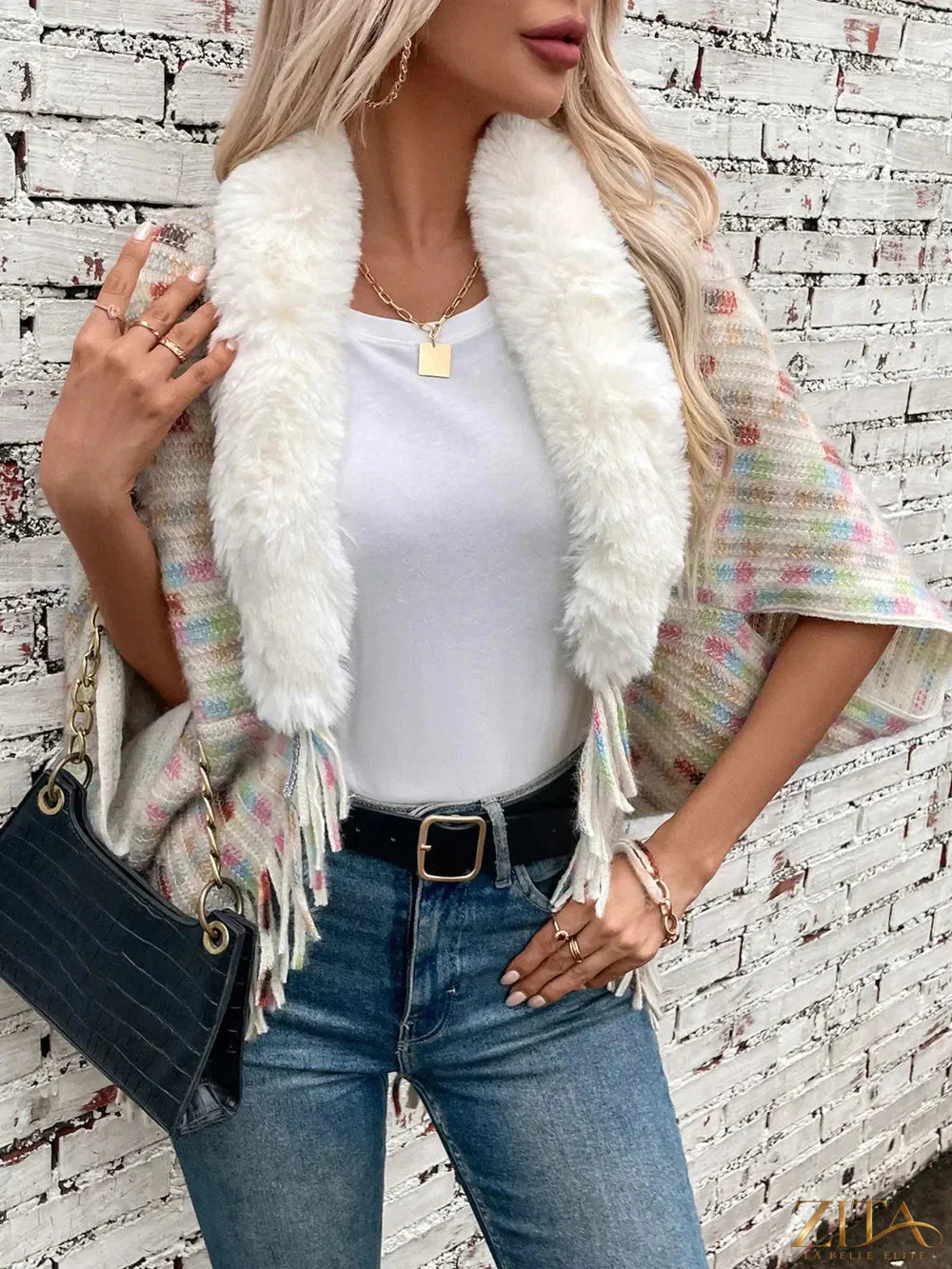Fuzzy open front fringe poncho in neutral tones, stylish and cozy, perfect for layering and adding texture to fall outfits.