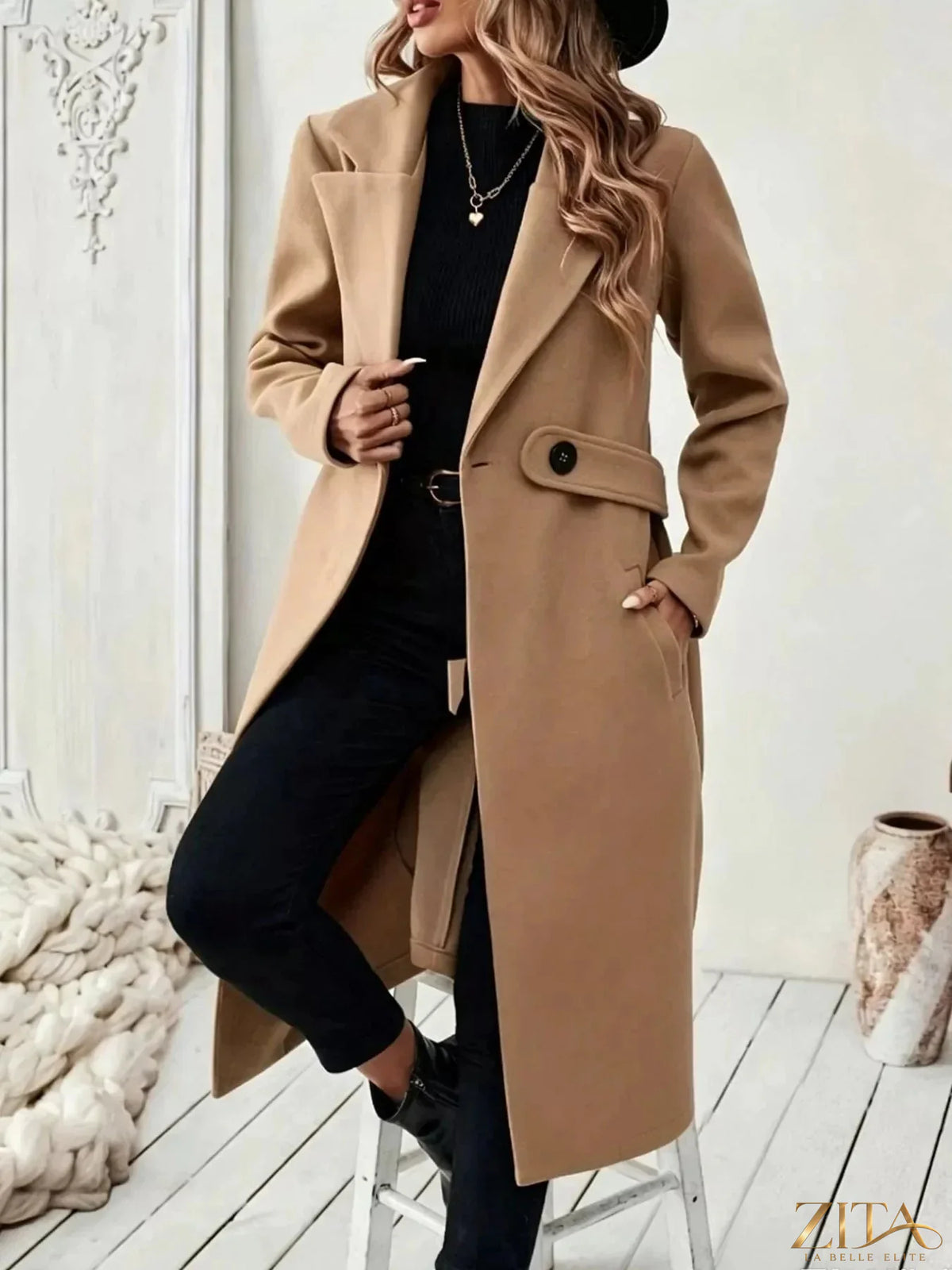 Zita La Belle Elite single-button longline coat in neutral fabric, shown on a hanger with a minimalist background.
