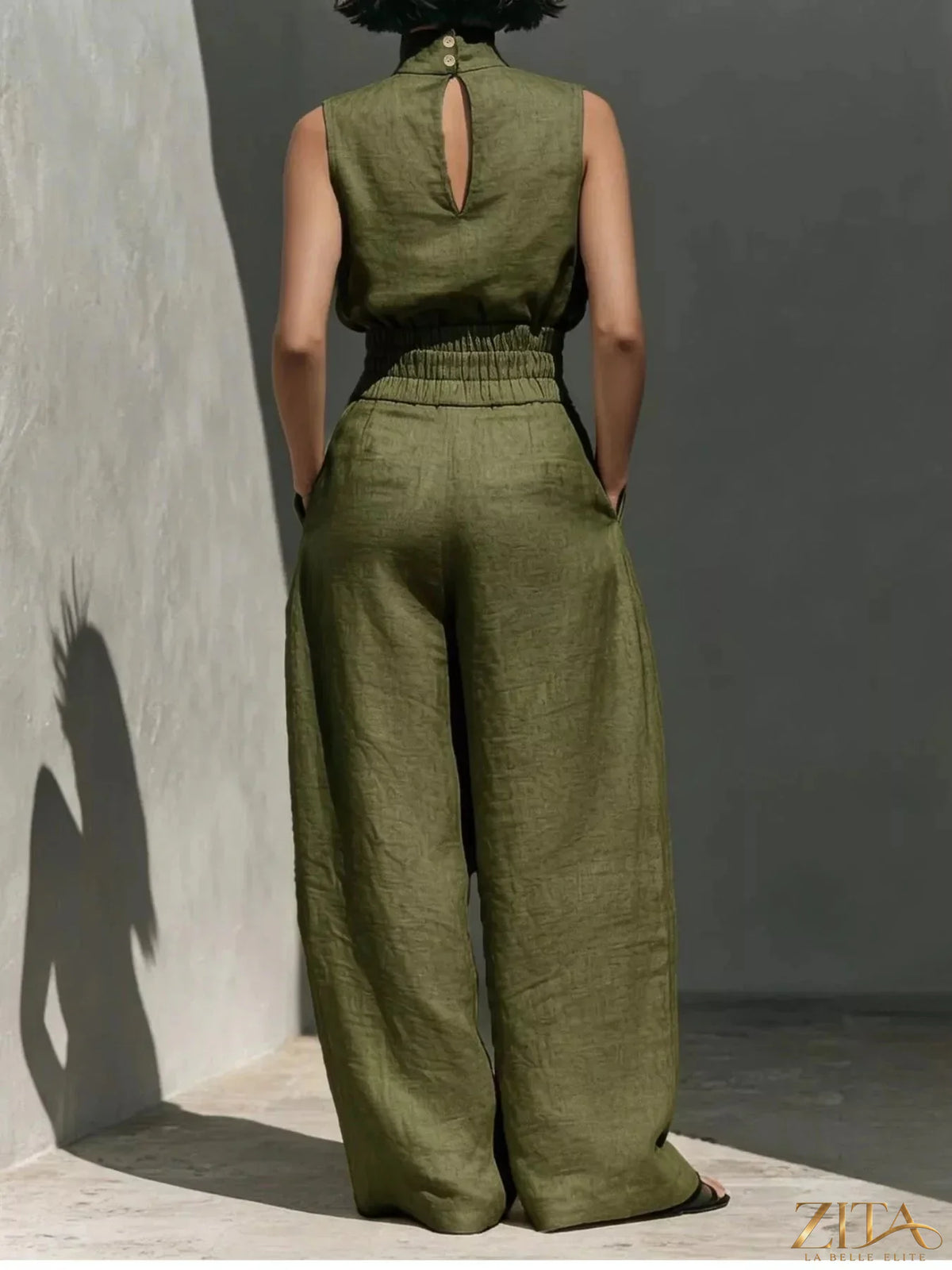 Sleeveless turtleneck top with wide-leg pants set from Trendsi, featuring a stylish and modern matching outfit in neutral tones.