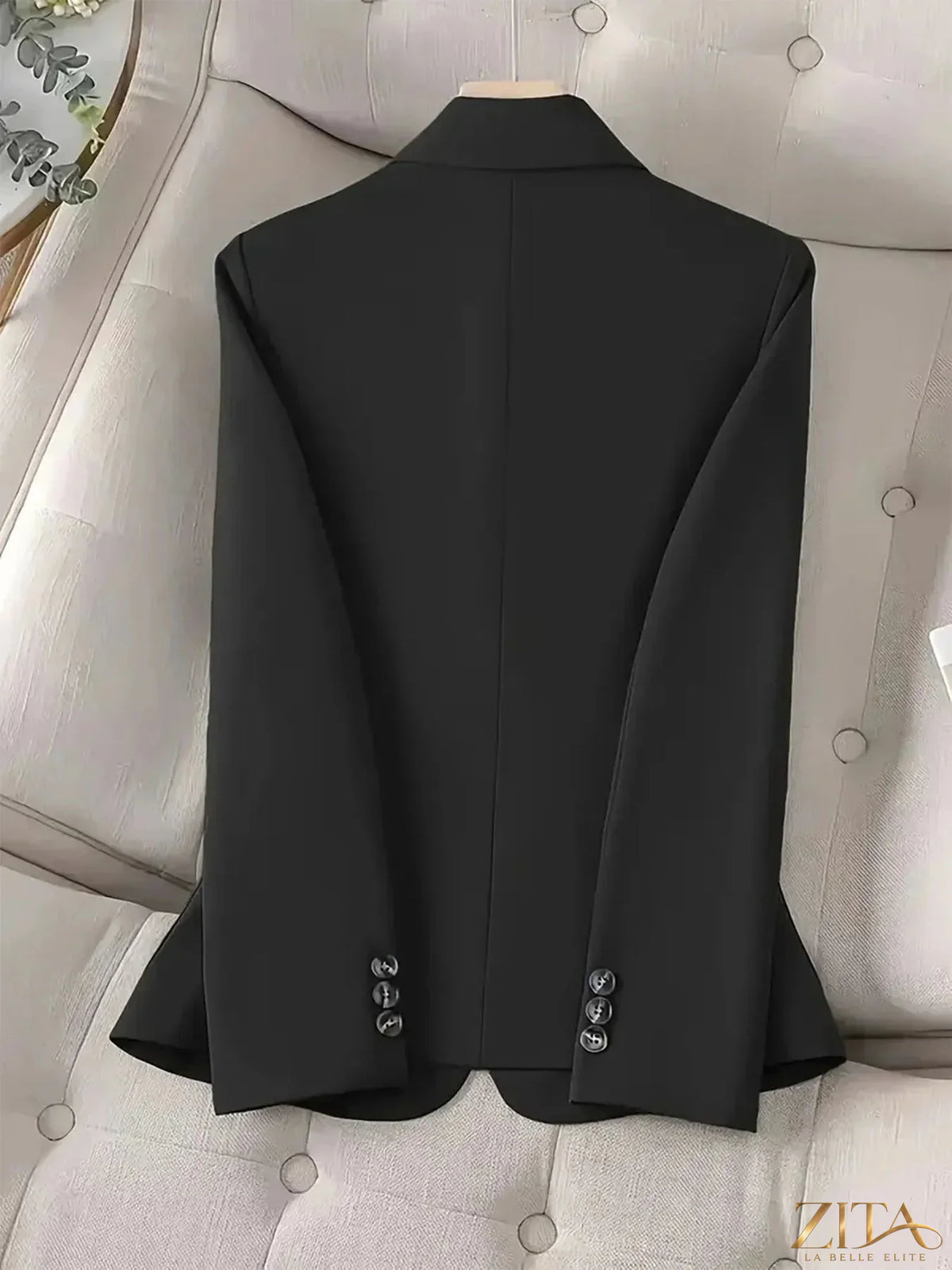 Black one-button blazer with front pockets, tailored fit, from Trendsi, displayed on a mannequin for a stylish professional look.