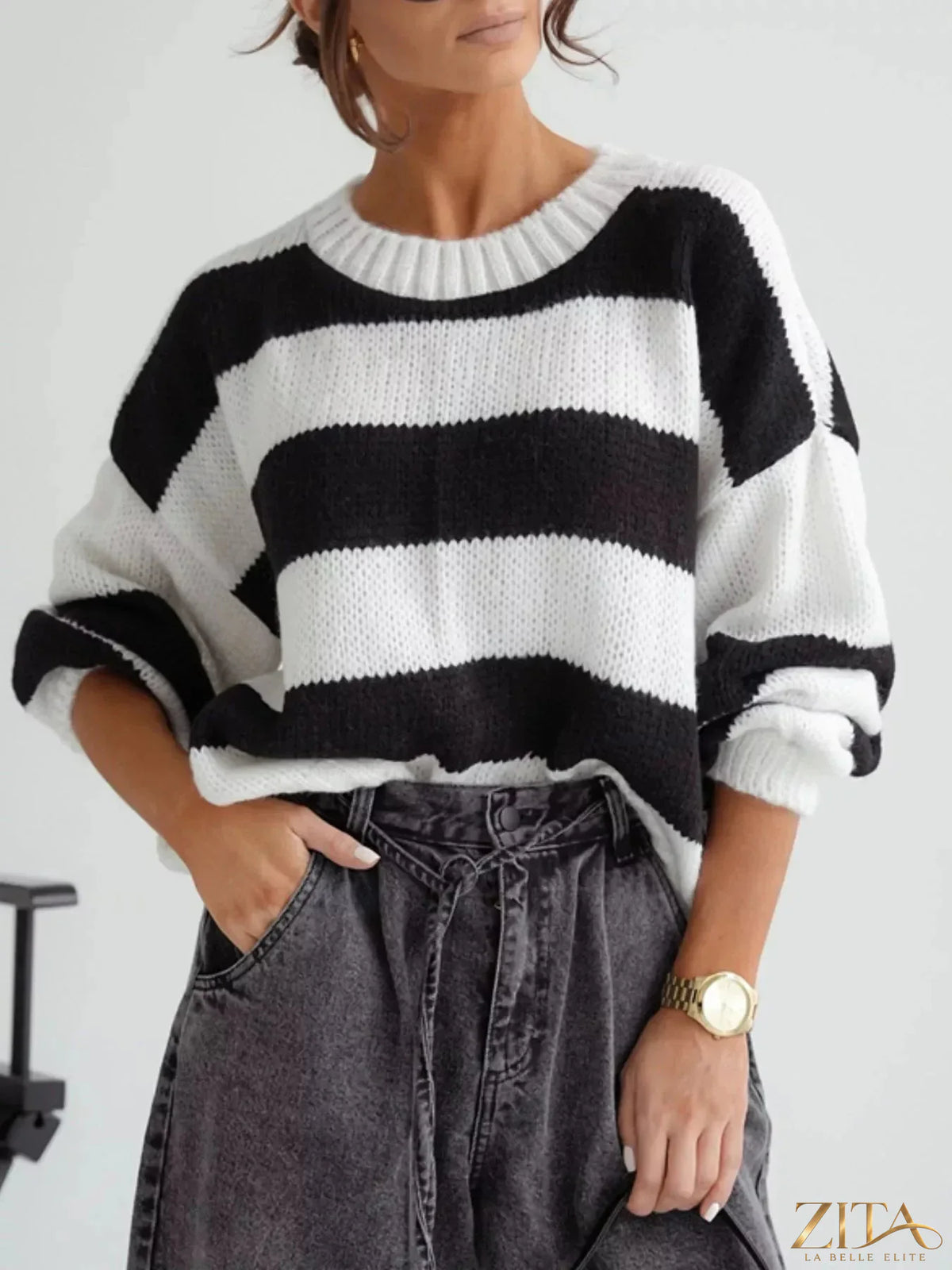 Striped dropped shoulder sweater from Trendsi featuring a cozy knit fabric and relaxed fit with bold horizontal stripes.