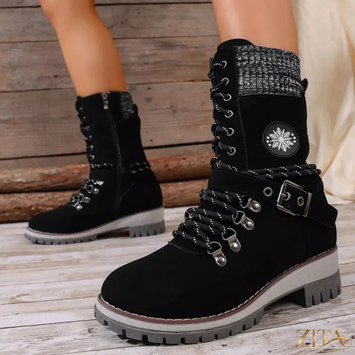 Black lace-up ankle combat boots with chunky soles and silver eyelets, stylishly designed for trendy footwear.