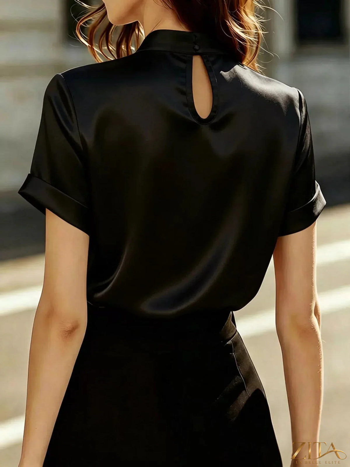 Pearl-embellished satin blouse by Zita La Belle Elite, featuring elegant detailing and smooth fabric.