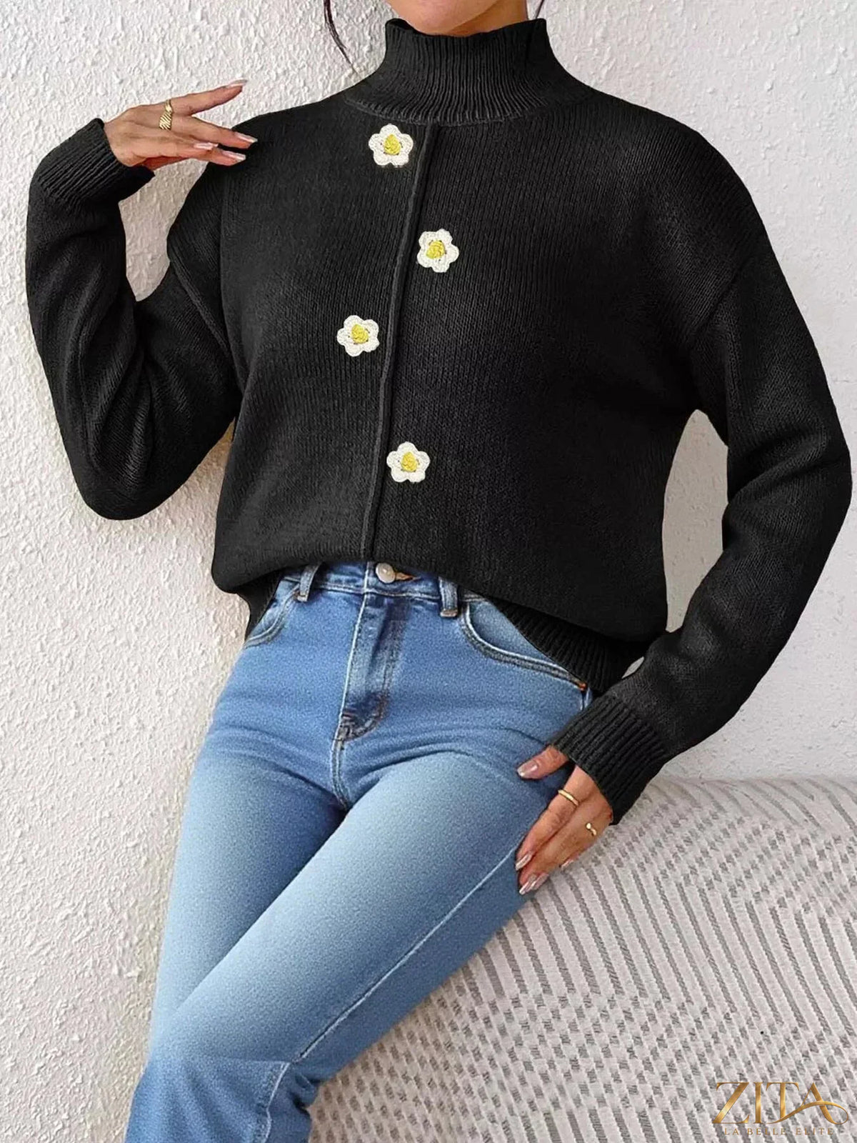 Zita La Belle Elite floral applique turtleneck sweater featuring a cozy knit design with colorful floral embroidery on a black background.
