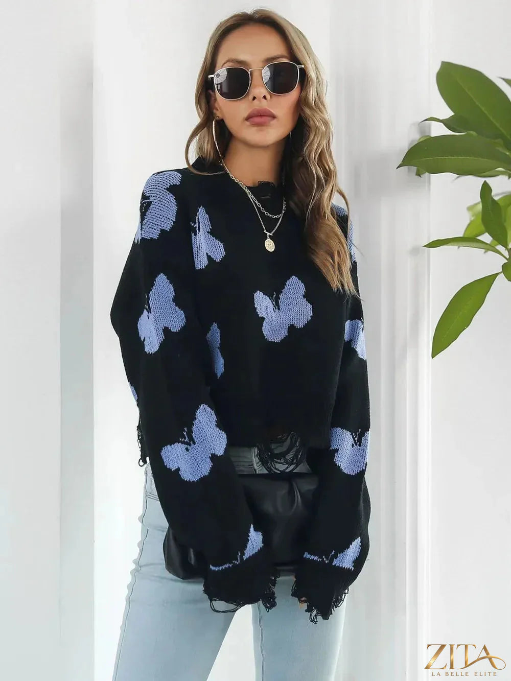 Zita La Belle Elite distressed butterfly cropped sweater featuring a worn design and delicate butterfly print on soft knit fabric.
