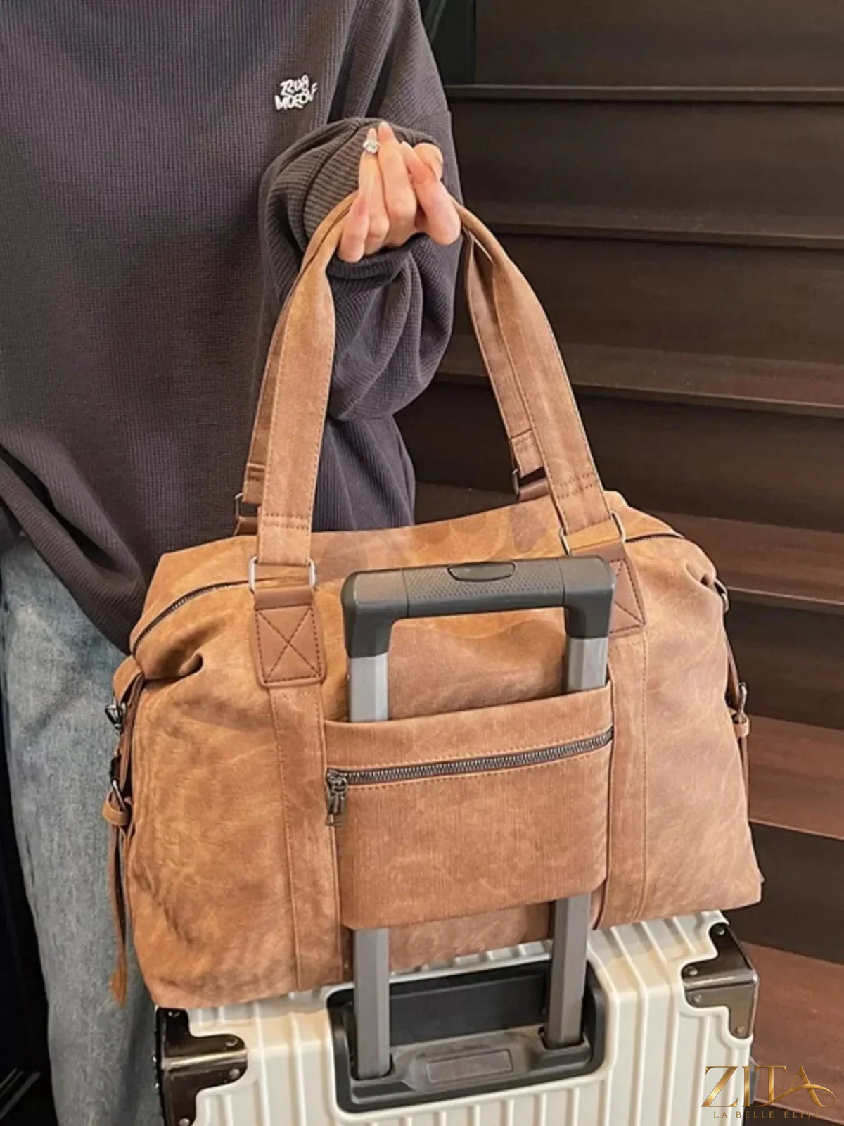 Vintage Zita La Belle Elite adjustable strap duffel bag with leather accents and spacious main compartment, placed on a neutral background.