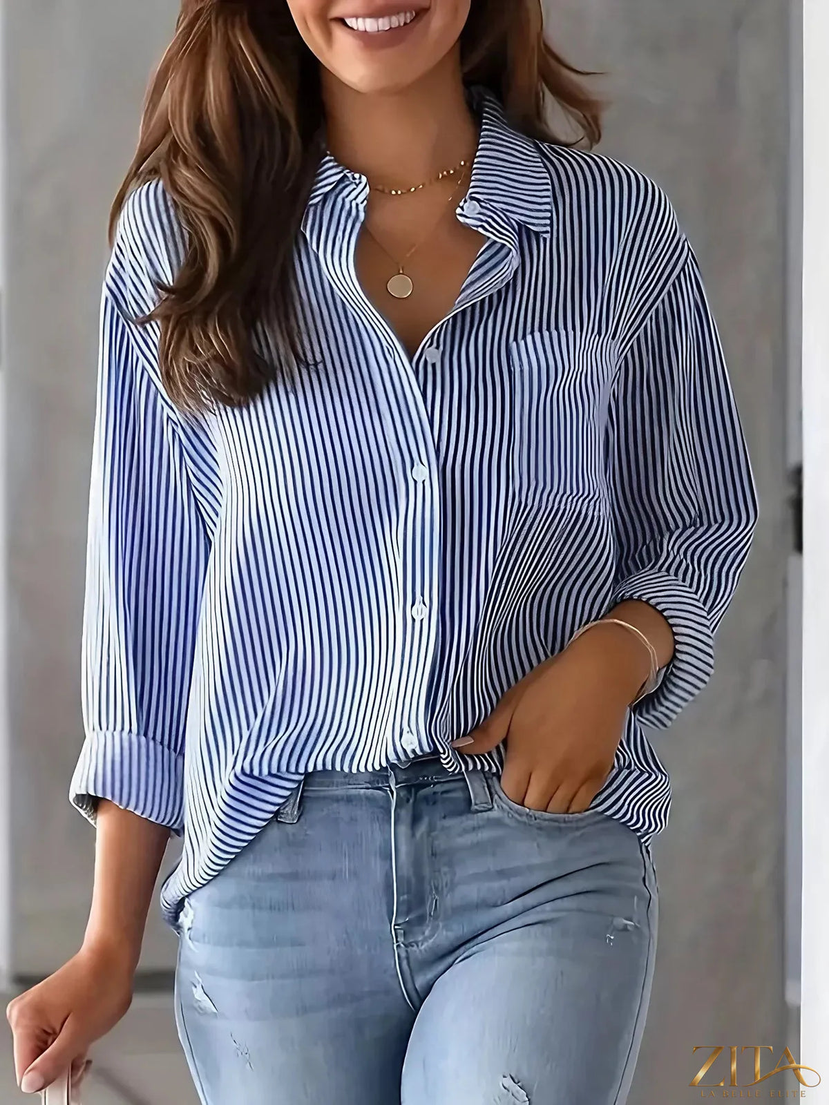 Zita La Belle Elite classic striped button-down shirt in blue and white, displayed flat with collar and long sleeves.