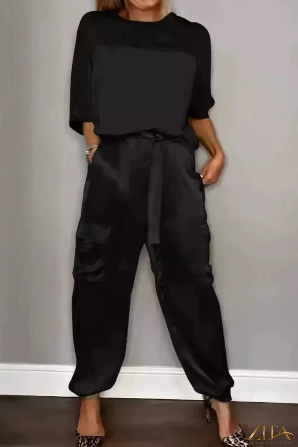 Satin round neck top and matching pants set by Trendsi, featuring a sleek, shiny fabric and relaxed fit.