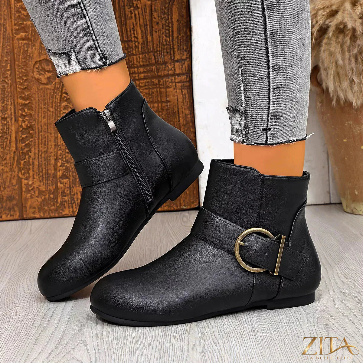 Round toe ankle boots from Trendsi featuring a sleek design, with a close-up view of the black leather material and sturdy sole.