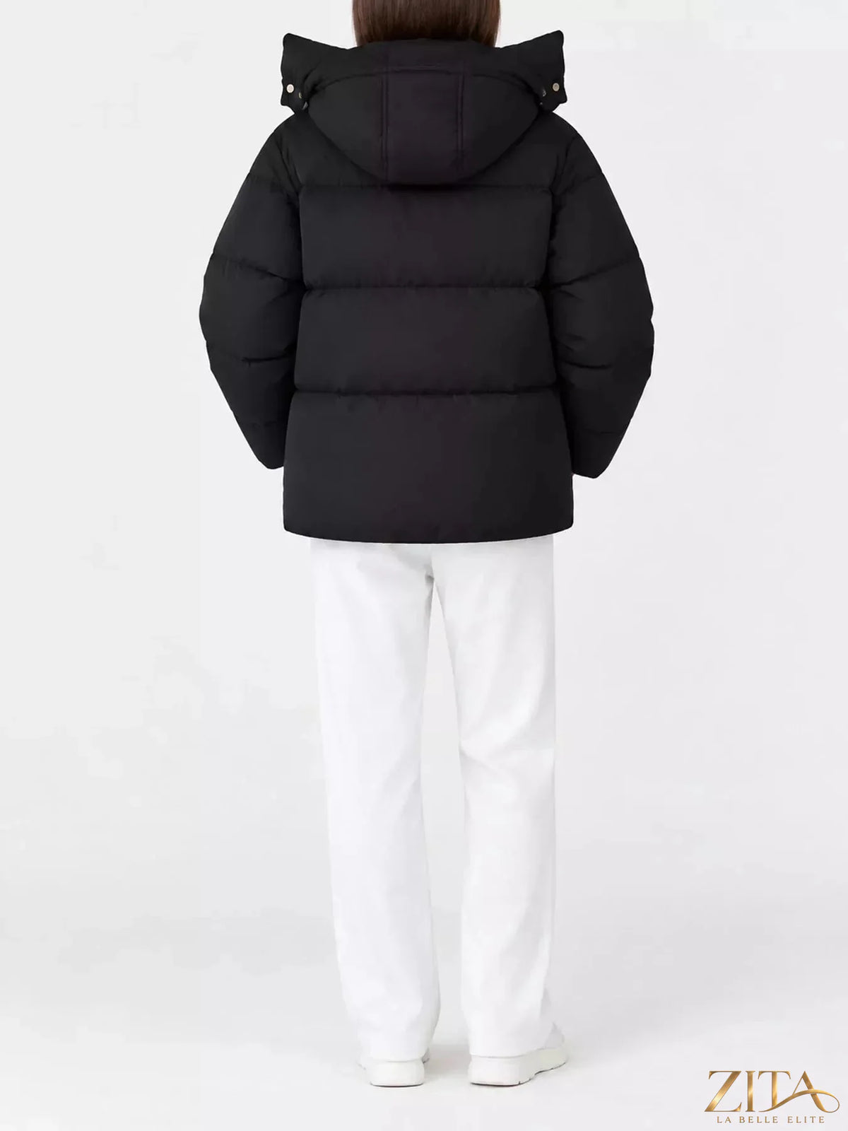 Zita La Belle Elite quilted hooded puffer jacket with insulated design and zip closure, displayed in a stylish outdoor setting.
