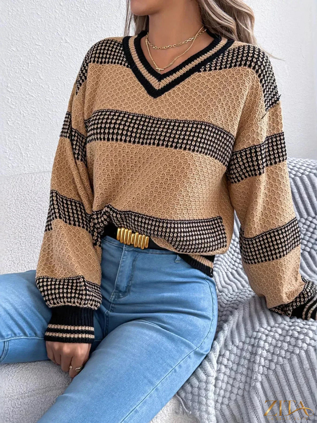 Contrast striped V-neck sweater by Trendsi featuring a stylish V-neck design and bold striped pattern in contrasting colors.