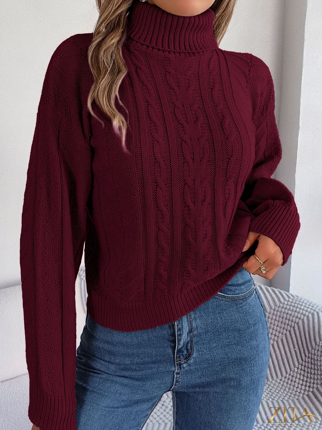 Zita La Belle Elite cable-knit turtleneck sweater in cozy wool with a classic ribbed collar and textured knit pattern.