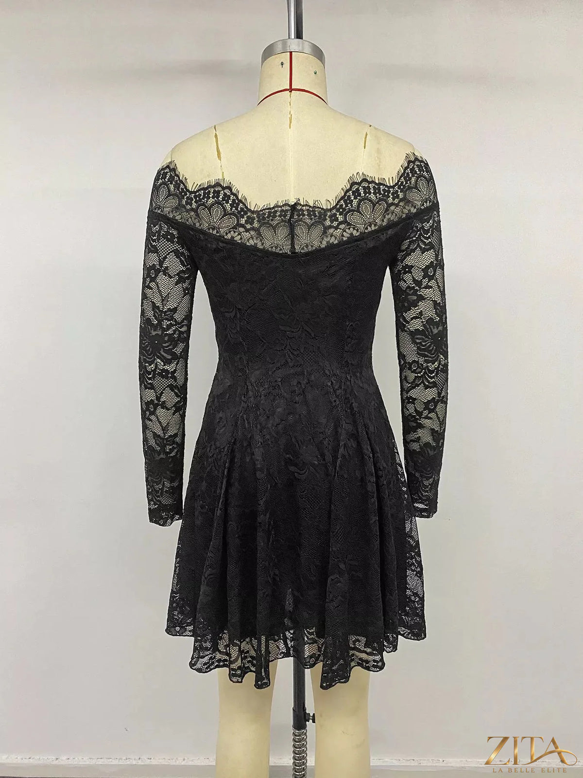 Zita La Belle Elite lace off-shoulder mini dress featuring delicate lace fabric and a fitted silhouette on a model.
