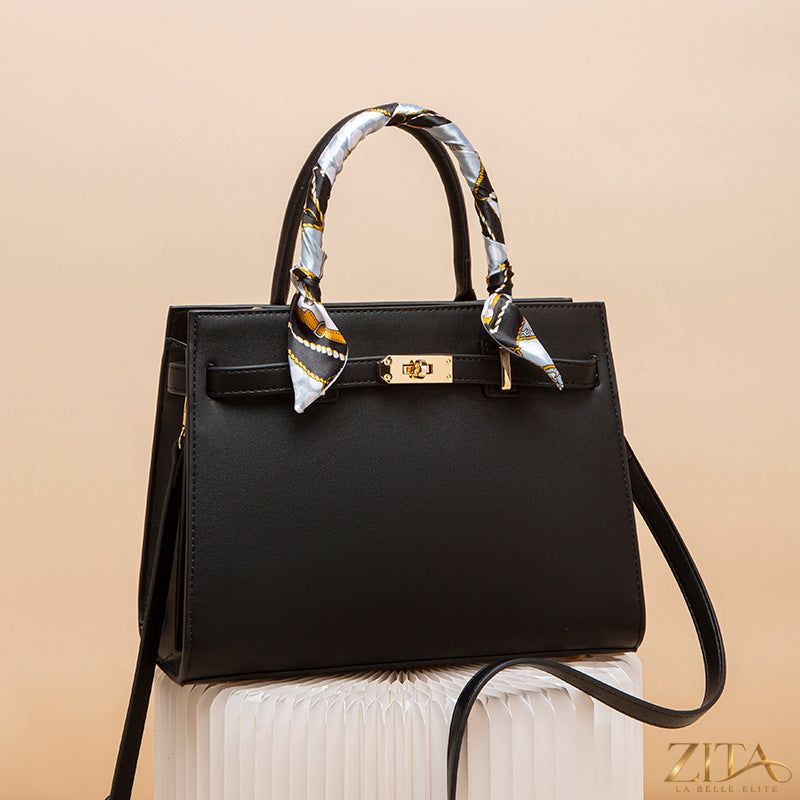 Zita La Belle Elite leather handbag with top handle, featuring a sleek design and smooth brown leather exterior.