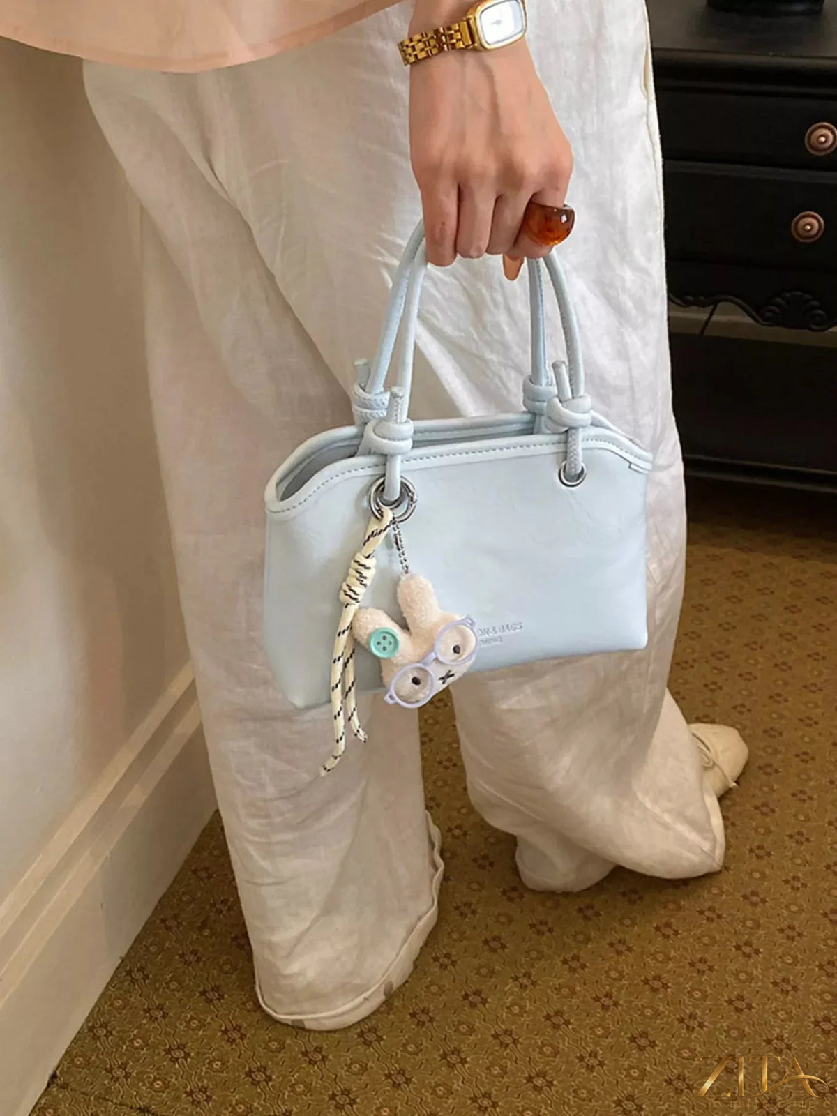 Trendsi PU leather handbag with top handles and gold-tone hardware, showcasing a stylish, structured design.