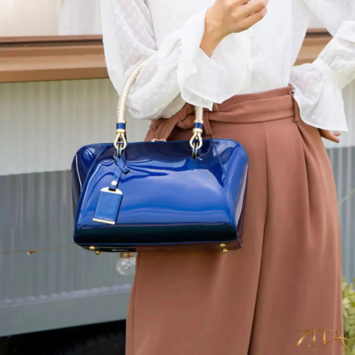 Zita La Belle Elite top handle handbag with high-gloss finish, featuring a sleek design and sturdy handle for stylish carrying.