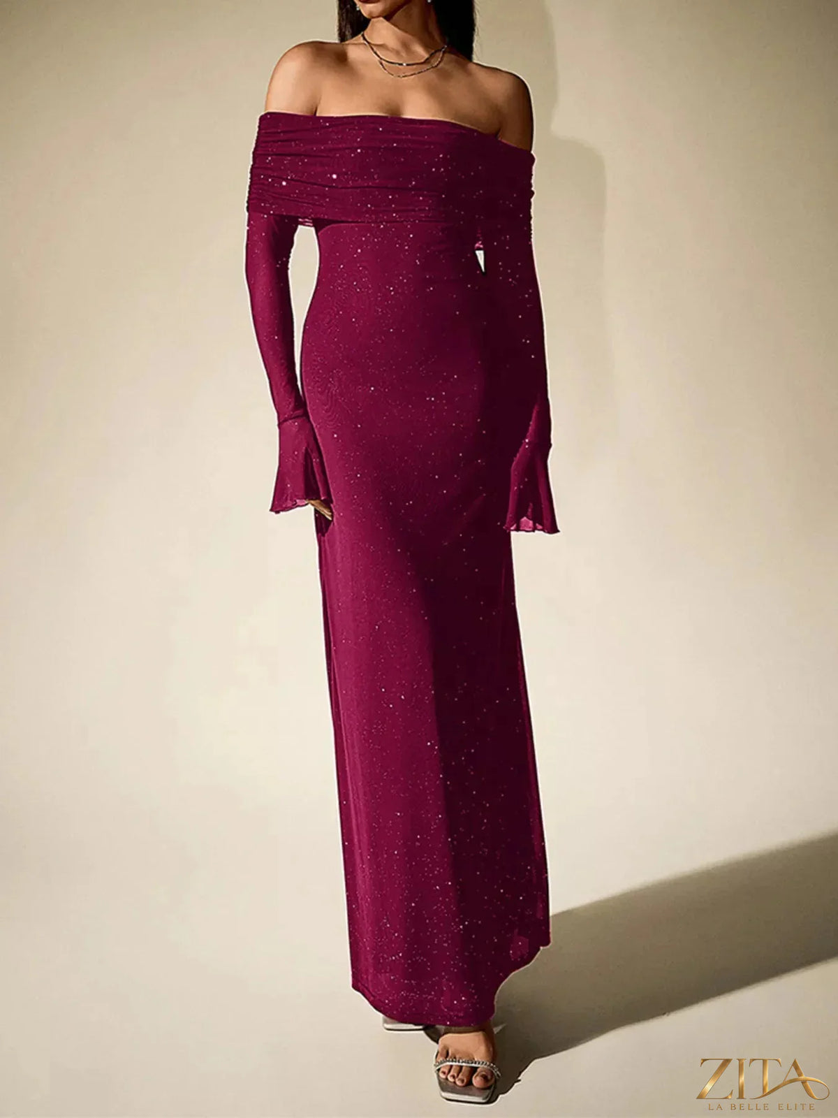 Zita La Belle Elite glitter off-shoulder maxi dress with a flowing silhouette and shimmering fabric, perfect for elegant occasions.