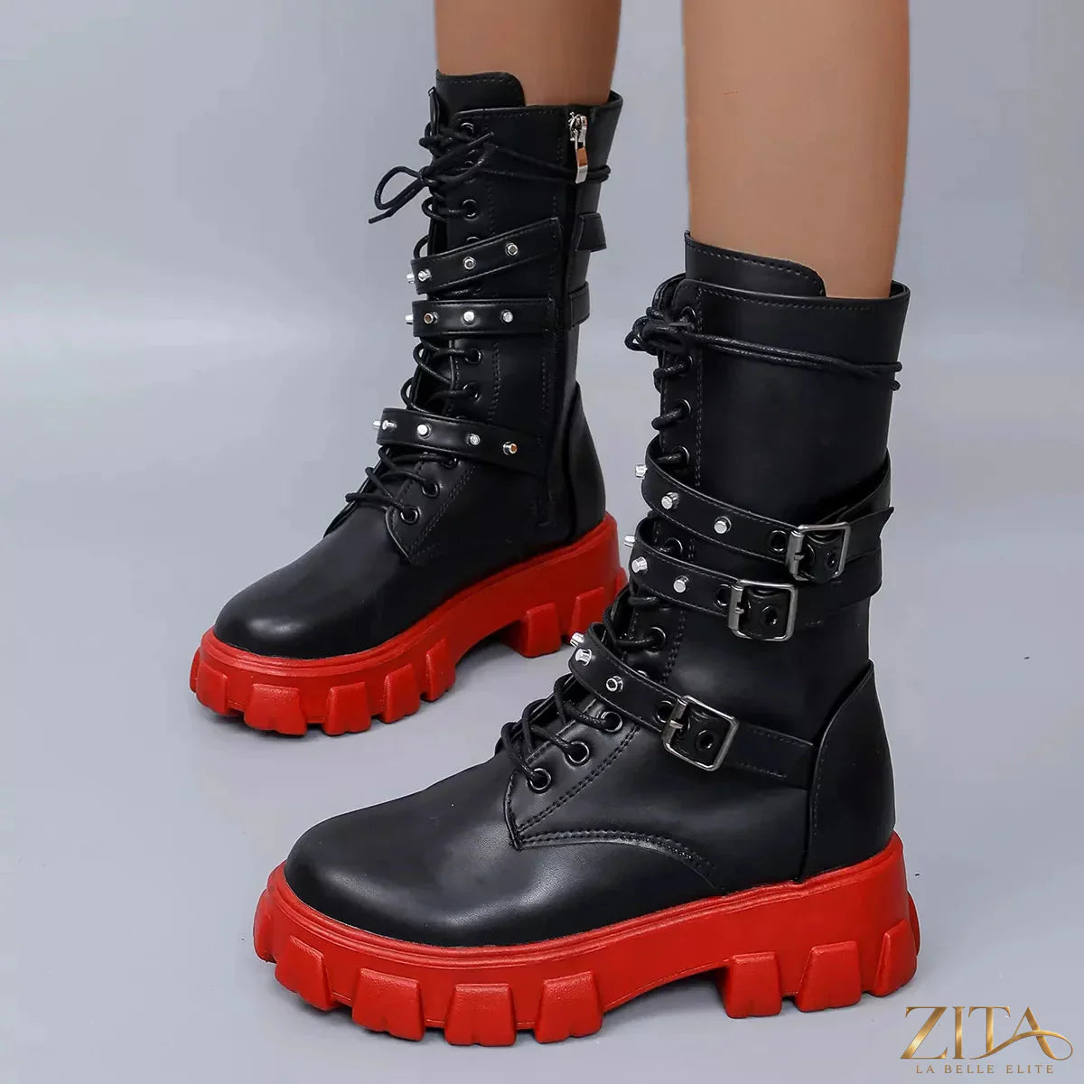 Black buckled lace-up combat boots from Trendsi with sturdy soles and metal eyelets, stylish and durable footwear for edgy fashion.