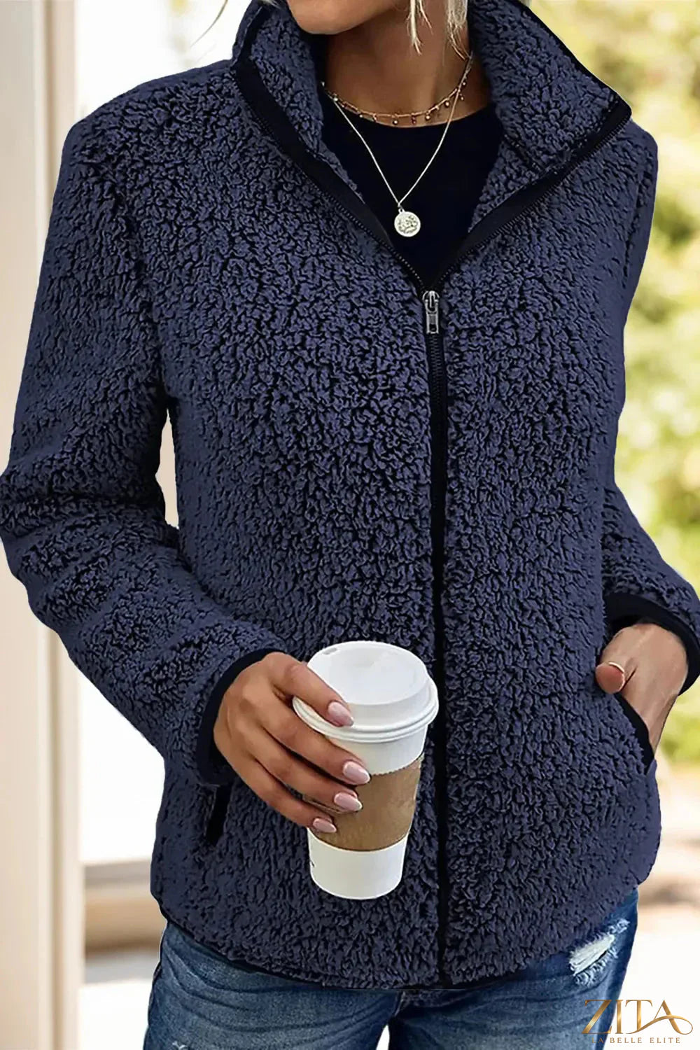 Trendsi pocketed zip-up turtleneck jacket showing black fabric, front pockets, and full zip closure, casual and stylish design.