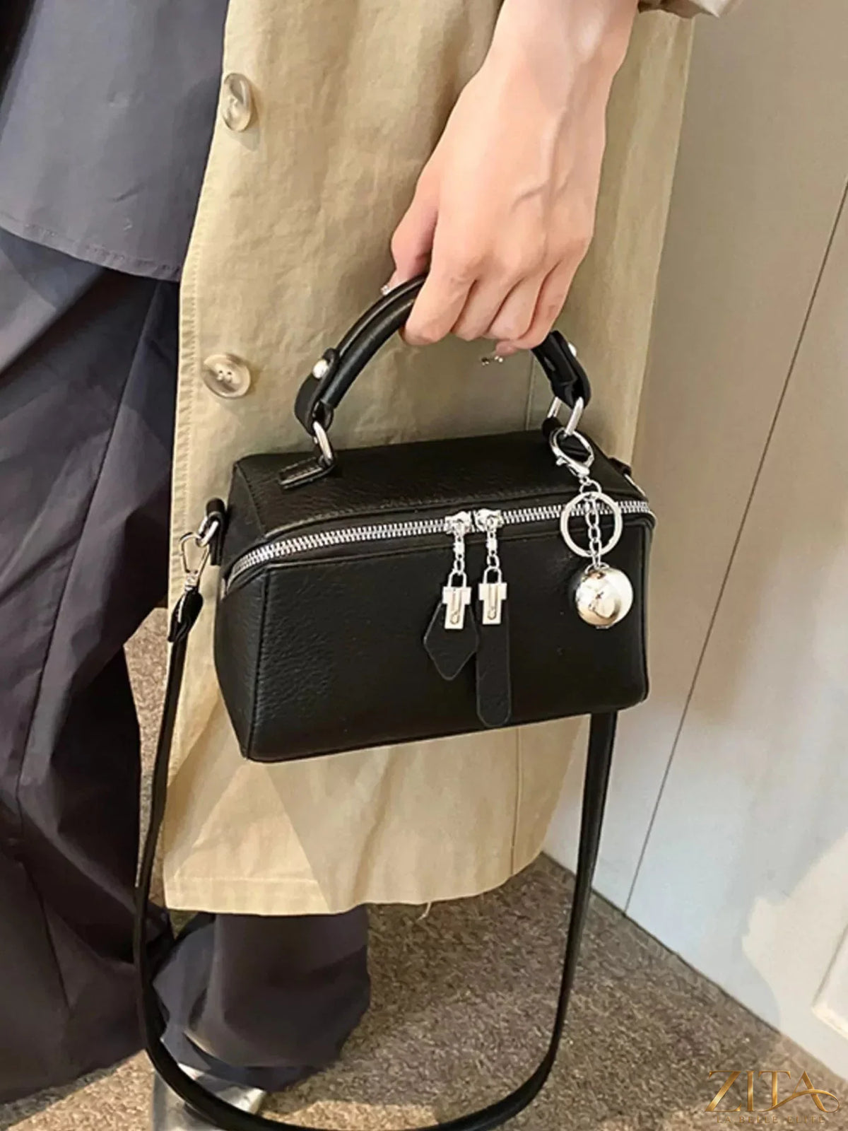 Textured leather handbag by Trendsi featuring a sleek design, top handle, and subtle detailing in natural lighting.