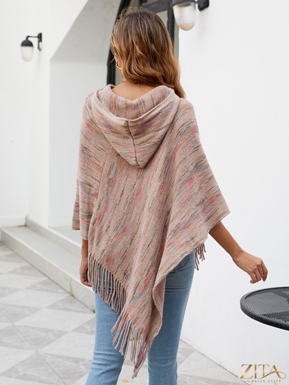 Zita La Belle Elite fringe hem hooded poncho in cozy fabric with tassel details, draped on a mannequin.