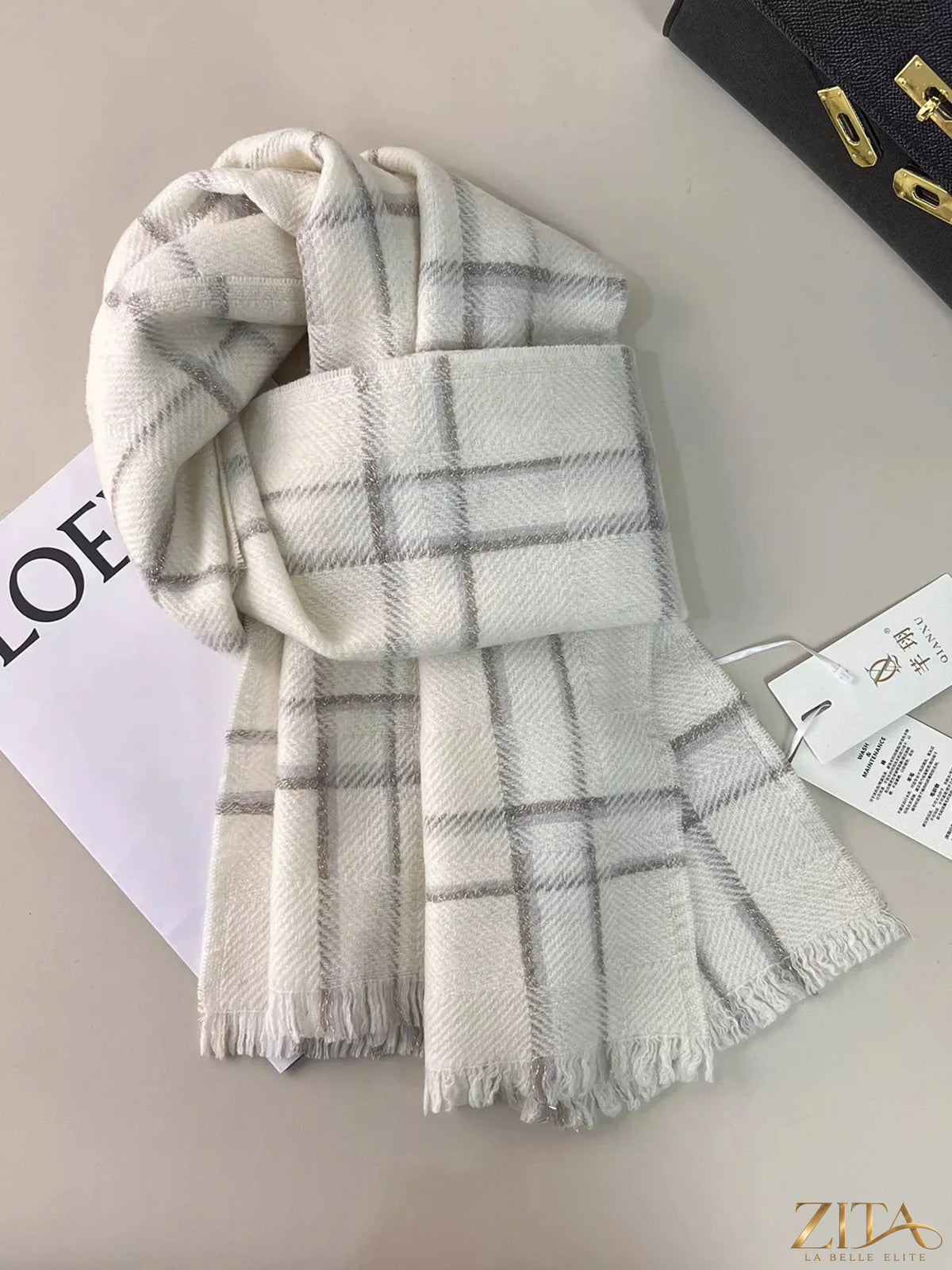 Zita La Belle Elite 100% wool raw hem plaid scarf, showcasing its cozy, warm fabric with classic tartan pattern and fringed edges.