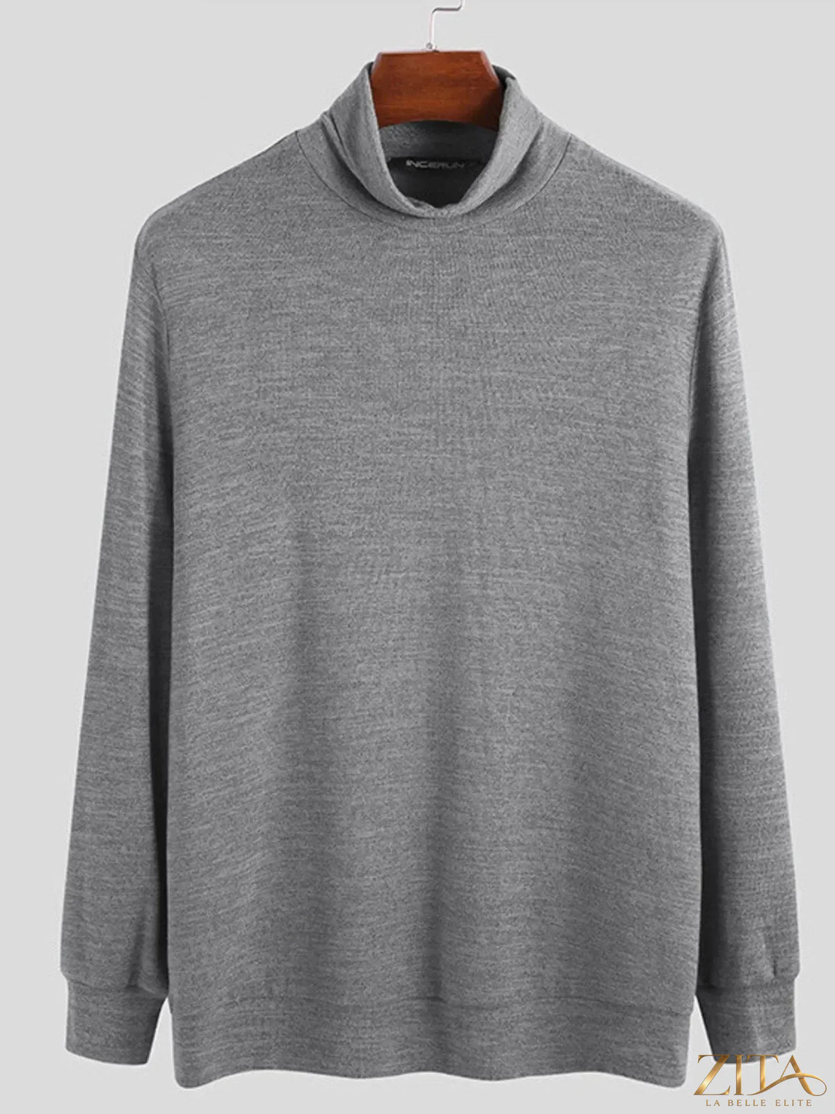 Plus size men's black turtleneck long sleeve top by Trendsi, made from soft, stretchy fabric, shown on a hanger.