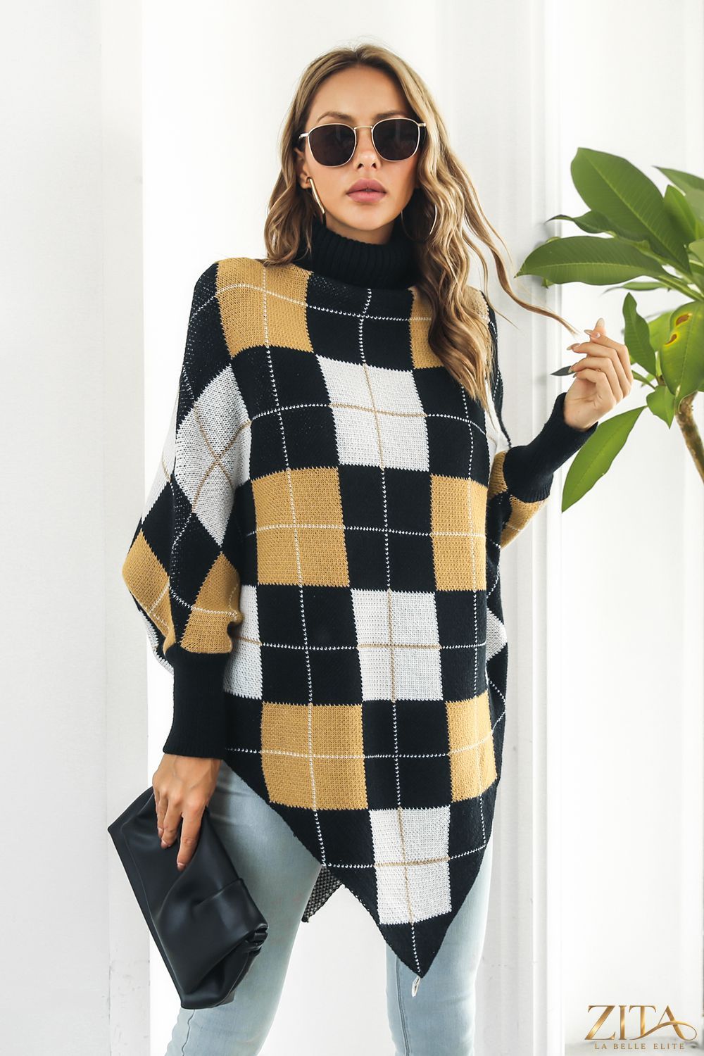 Plaid turtleneck dolman sleeve poncho in cozy fabric, featuring a classic pattern and relaxed fit, perfect for layered winter style.
