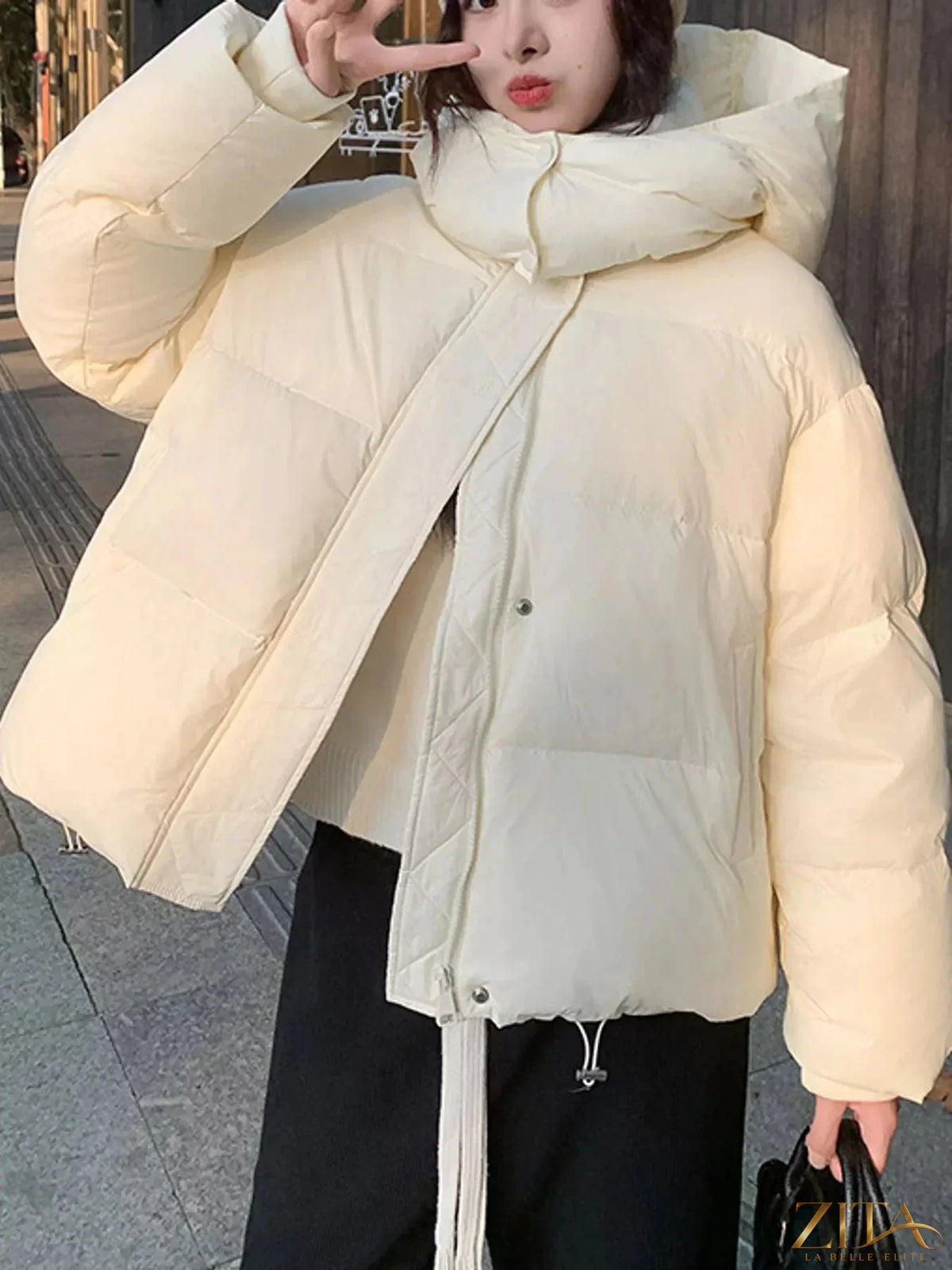Zita La Belle Elite quilted hooded puffer jacket in black with front zipper, cozy quilted design, and adjustable hood.