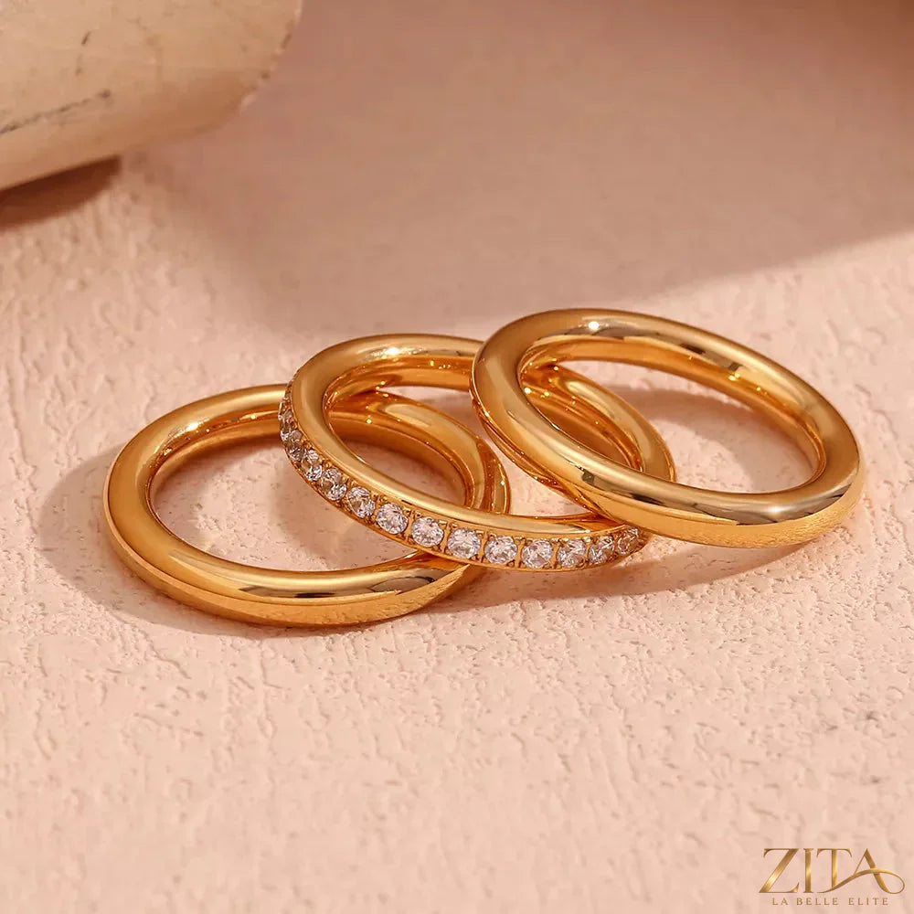 Three stainless steel zircon rings from Zita La Belle Elite, showcasing sparkling stones and sleek band designs.
