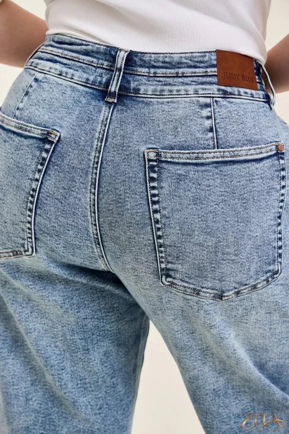 Judy Blue Marlow Arc Leg jeans with double waistband and distressed details, shown on a model.