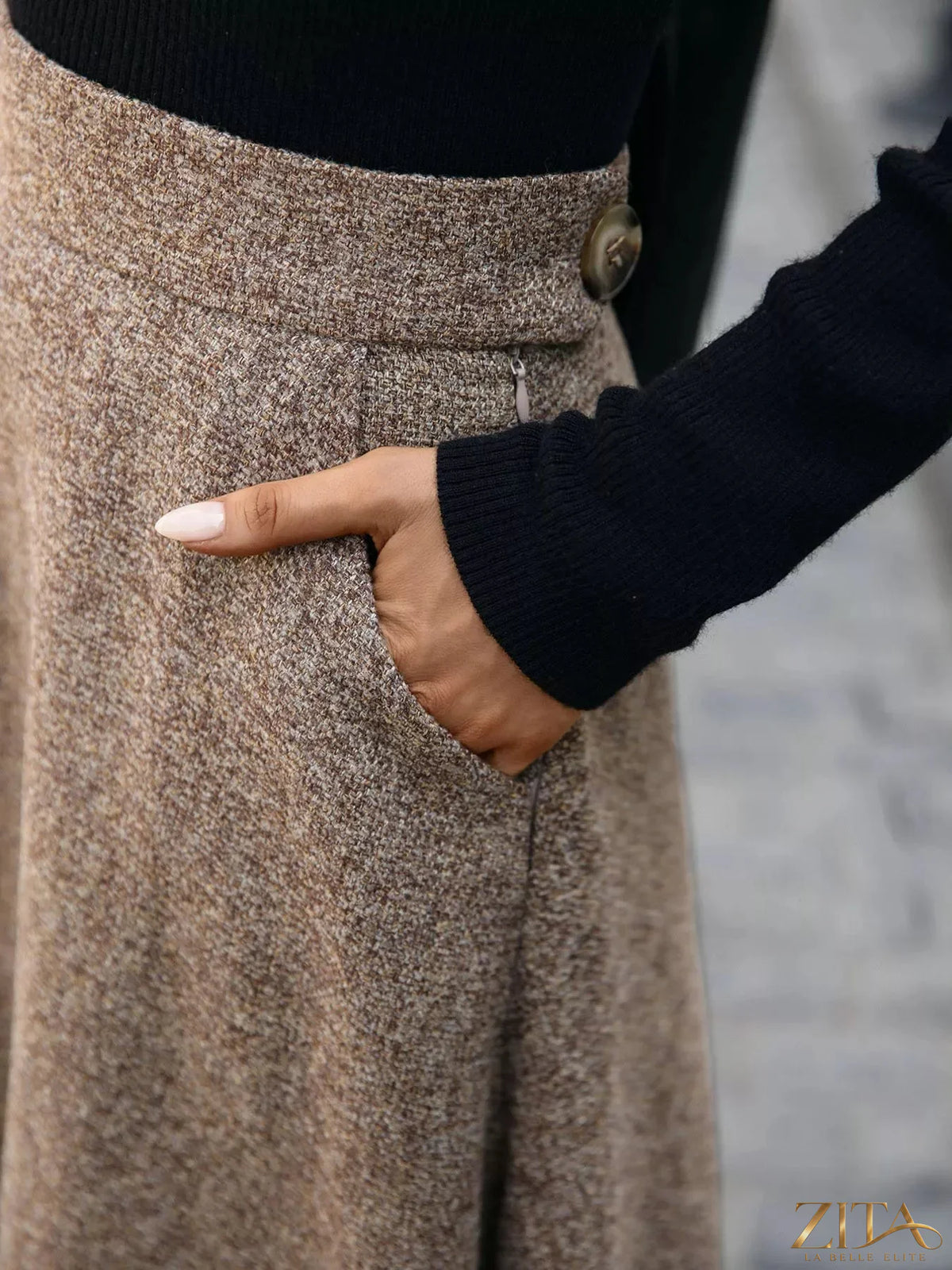 A-line midi skirt in a soft fabric, featuring a high waist and flowing silhouette, styled for a casual or formal look.